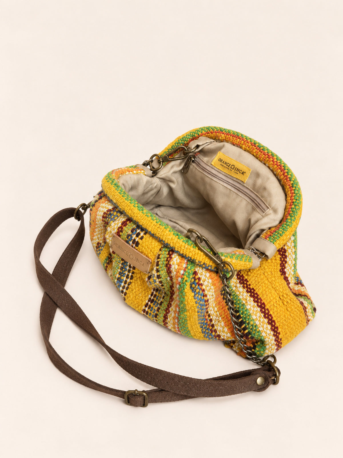 Inside the Alba kiss lock clutch in mustard with rainbow stripes – cotton drill lining, zip pocket and detachable faux suede and chain strap | Orange Inca