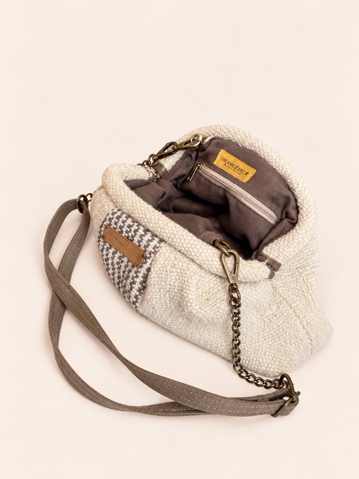 Inside the Alba kiss lock clutch in natural with grey blue stripes – cotton drill lining, zip pocket and detachable faux suede and chain strap | Orange Inca