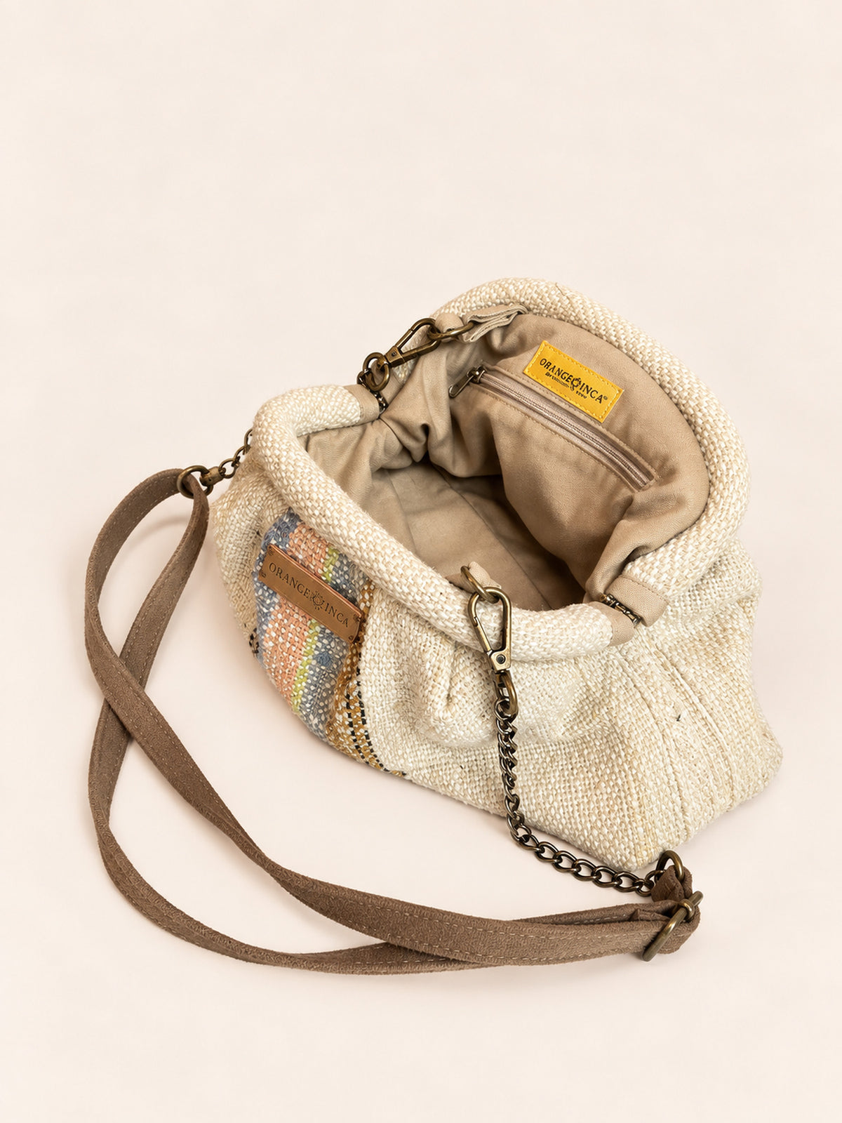 Inside the Alba kiss lock clutch in natural with pastel stripes – cotton drill lining, zip pocket and detachable faux suede and chain strap | Orange Inca