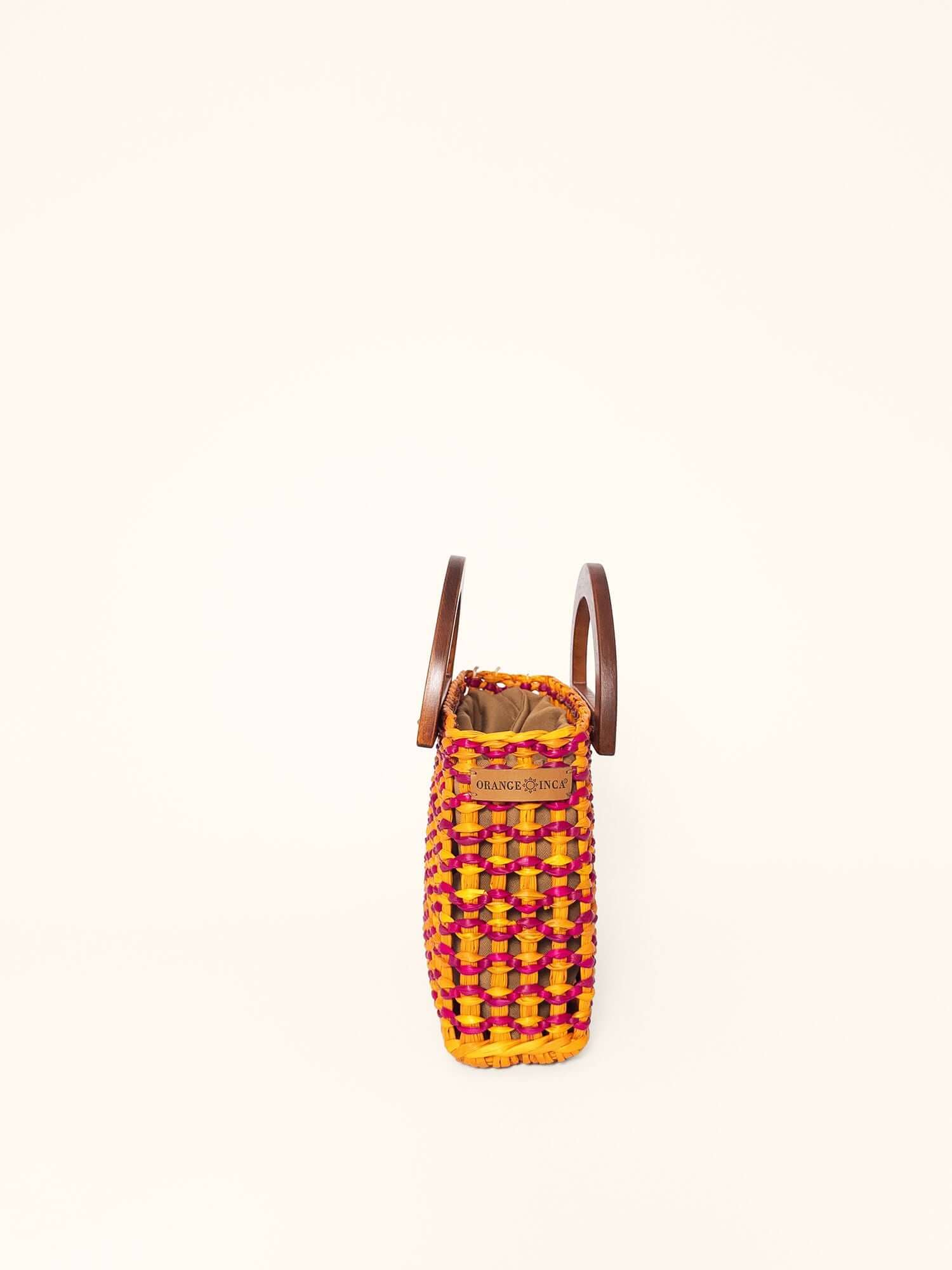 Brigitte handwoven bag fuchsia and yellow – styled, retro top-handle design | Orange Inca