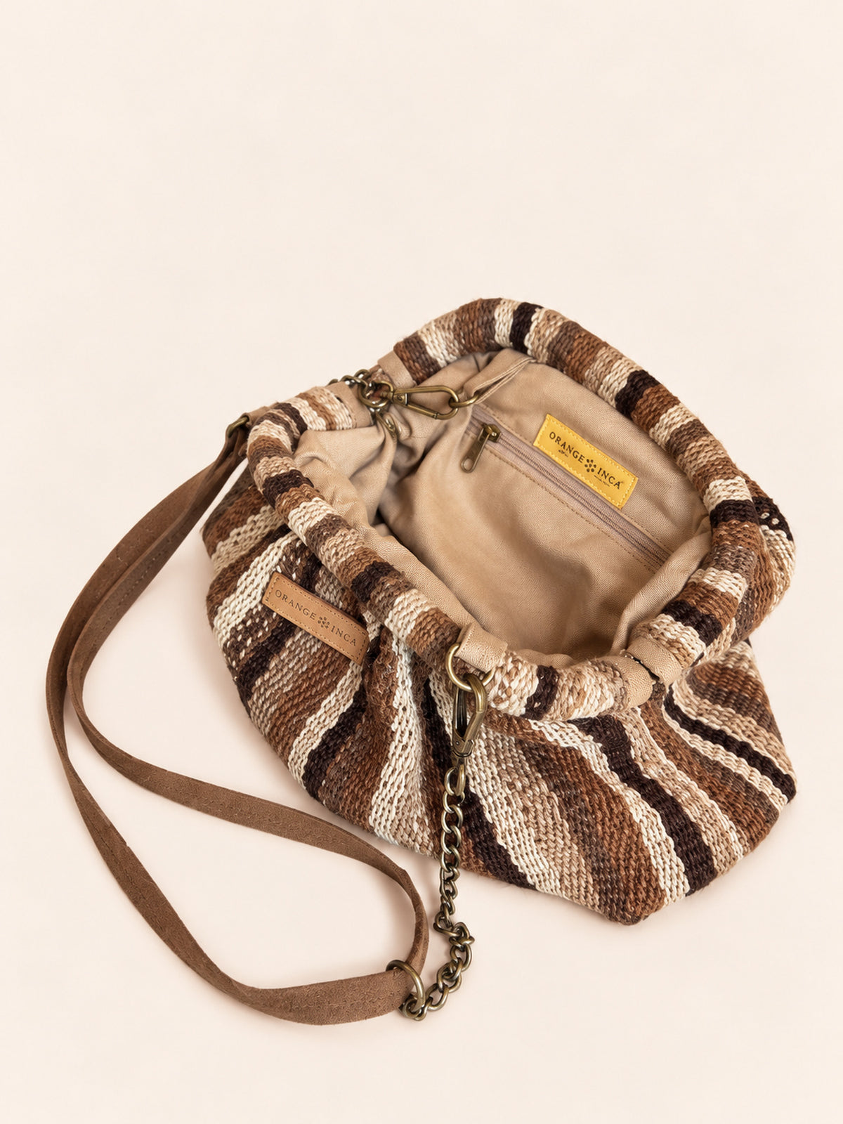 Inside the Luna kiss lock clutch in browns, black and ivory – cotton drill lining, zip pocket and detachable faux suede and chain strap | Orange Inca