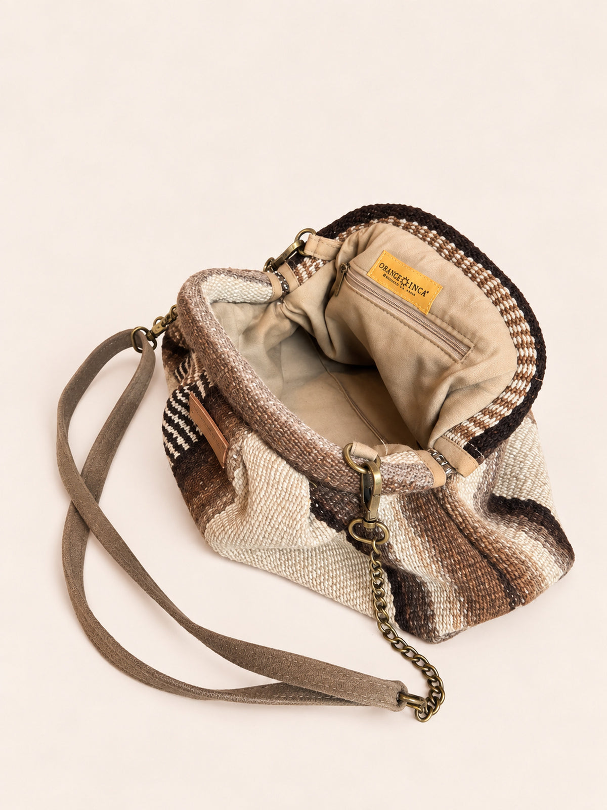 Inside the Luna kiss lock clutch in browns and ivory – cotton drill lining, zip pocket and detachable faux suede and chain strap | Orange Inca