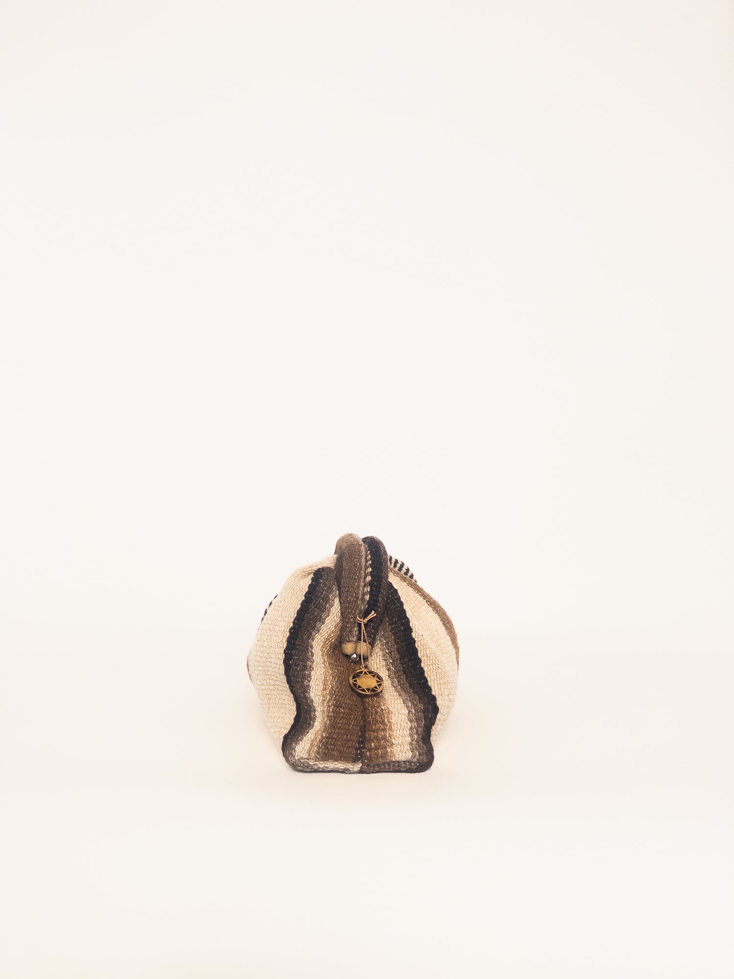 Luna kiss lock clutch in browns and ivory – textile-wrapped frame closure with artisan charm | Orange Inca