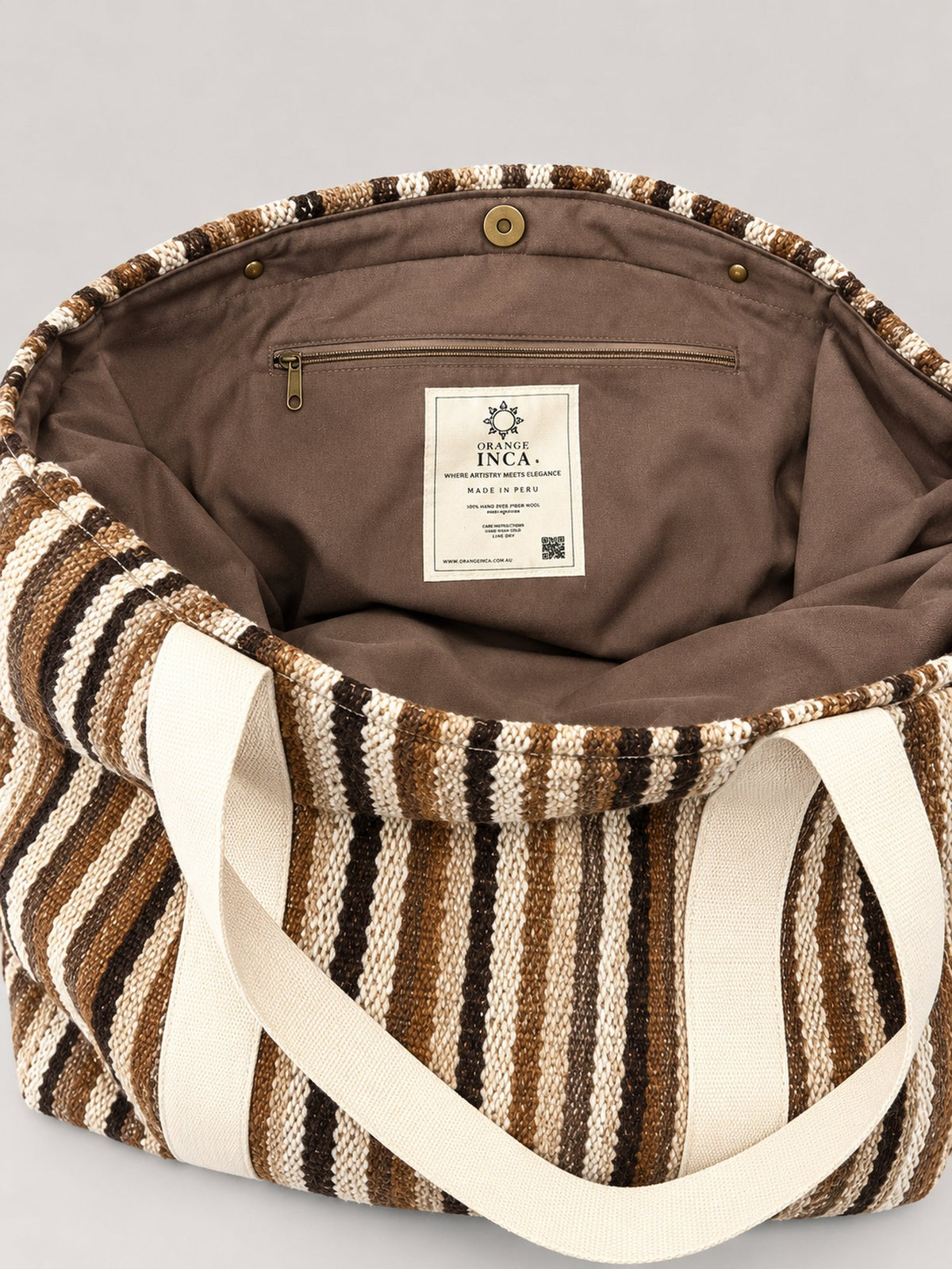 The Manta Carryall in Brown and Cream Stripes — inside: lining, magnetic snap closure and zip pocket