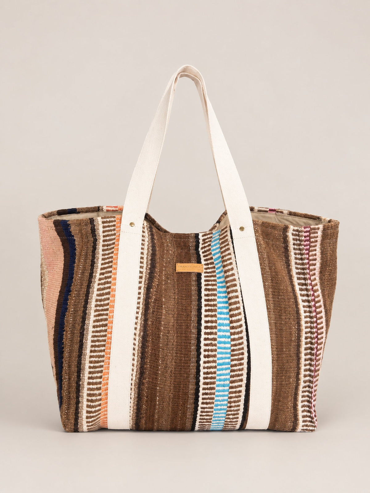 The Manta Carryall in Browns, Peach and Sky Blue — front view