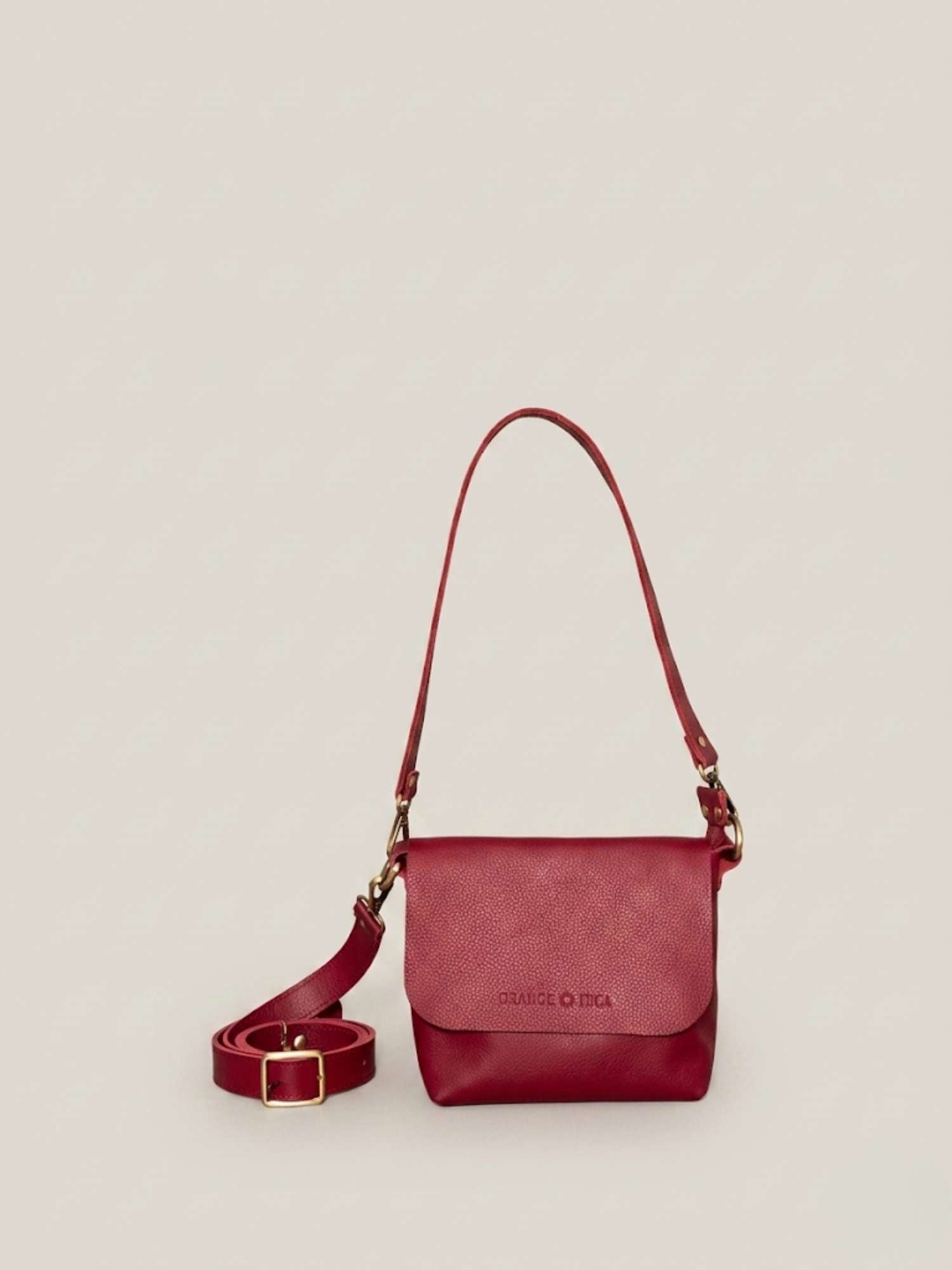 Burgundy full-grain leather crossbody by Orange Inca — front with strap coiled | Orange Inca