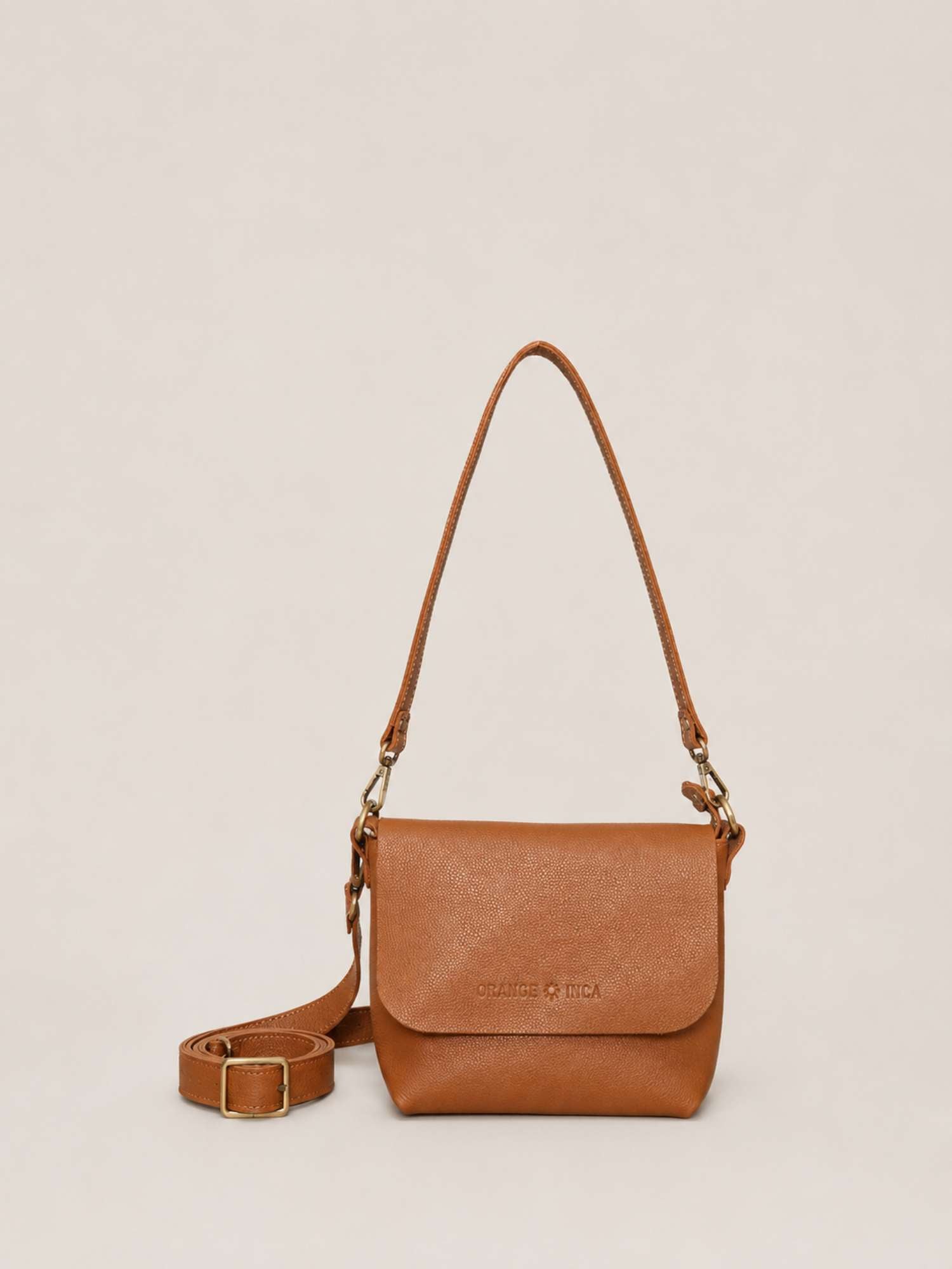 Cognac full-grain leather crossbody by Orange Inca — front with strap coiled | Orange Inca
