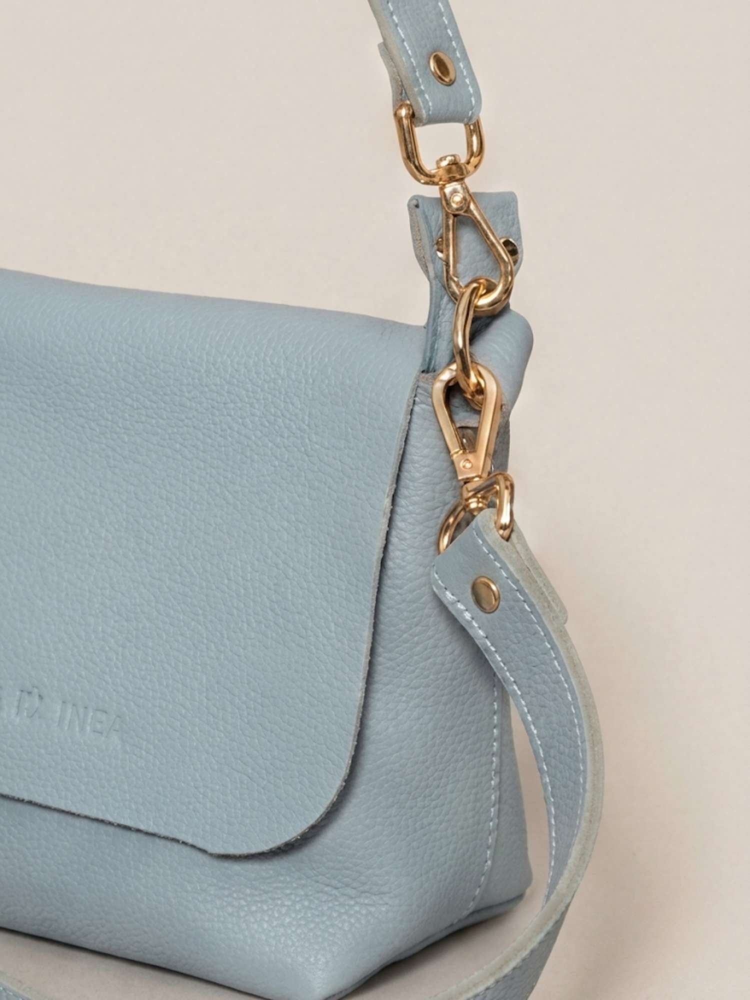 Powder Blue Olivia close-up — tumbled leather detail with polished gold hardware | Orange Inca