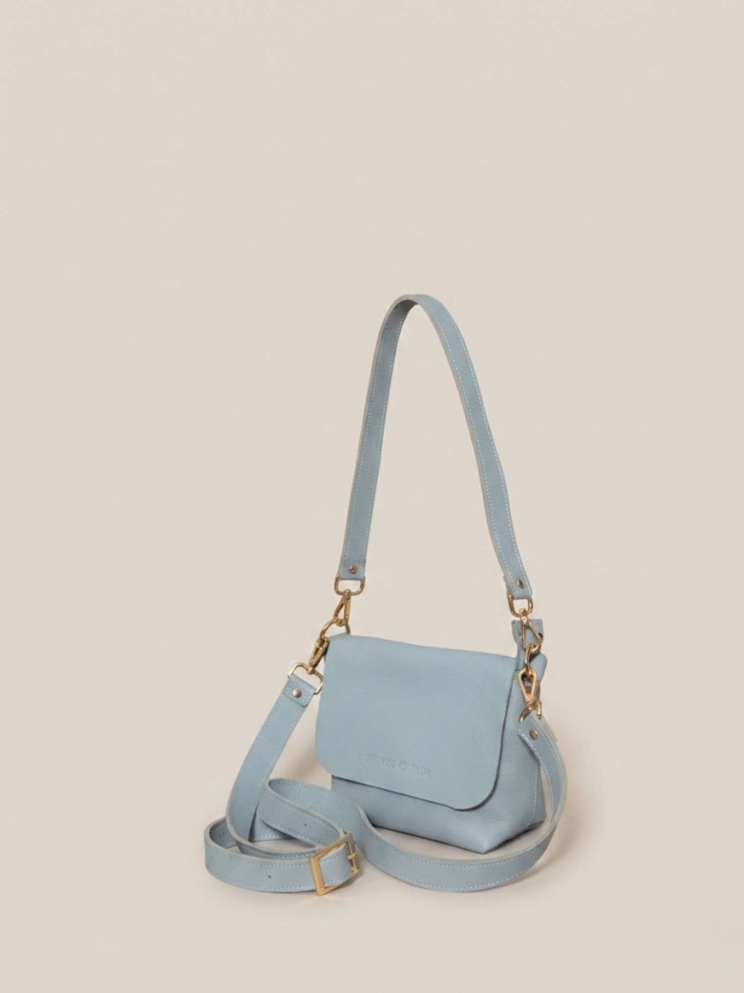 The Olivia Powder Blue leather crossbody — both straps shown (shoulder + crossbody) | Orange Inca
