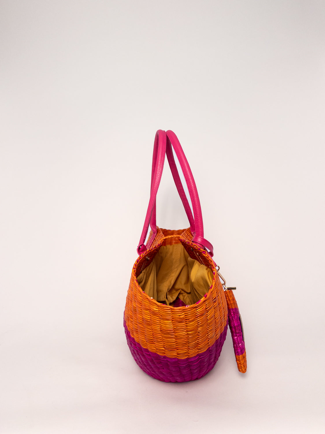 Playa Tote - Half Fuchsia Half Orange, handwoven junco tote bag, featuring natural dyes and faux leather straps.