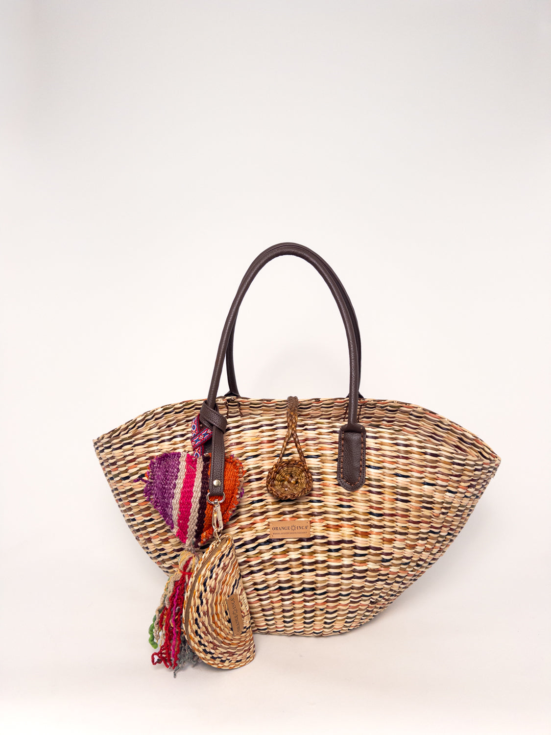 Playa Tote - Marbled Browns and Natural, handwoven junco tote bag with faux leather straps and colorful tassels.