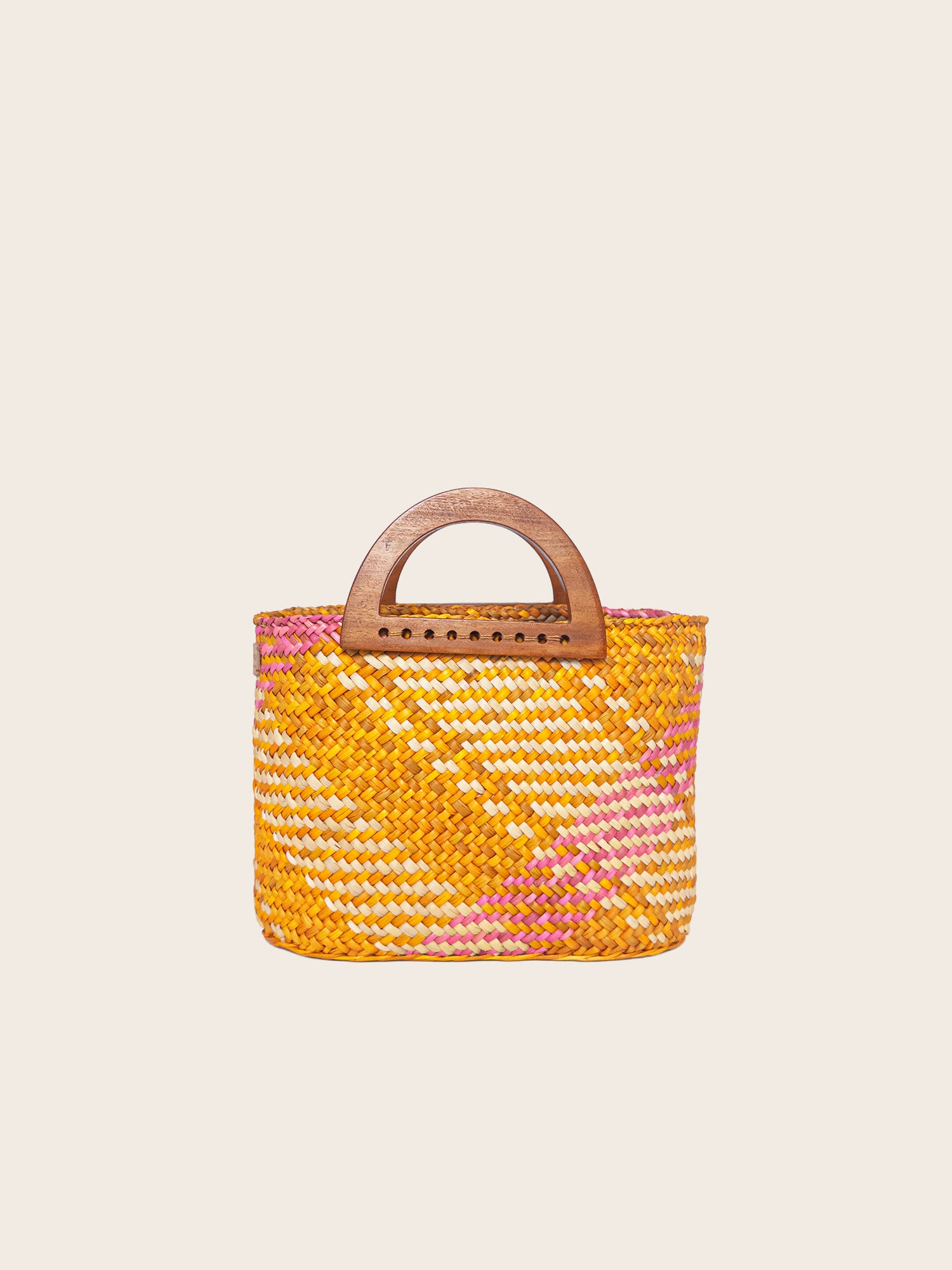 The Sophia handbag in washed yellow and pink, featuring handwoven design and wooden handles.