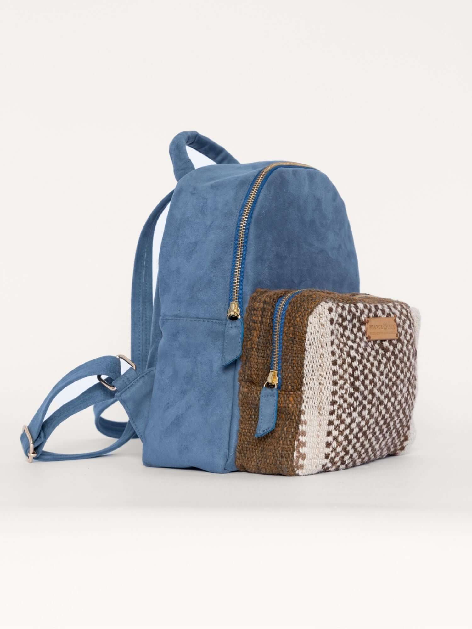 Side view of handmade wool and suede backpack – structured boho design with soft textures and natural tones