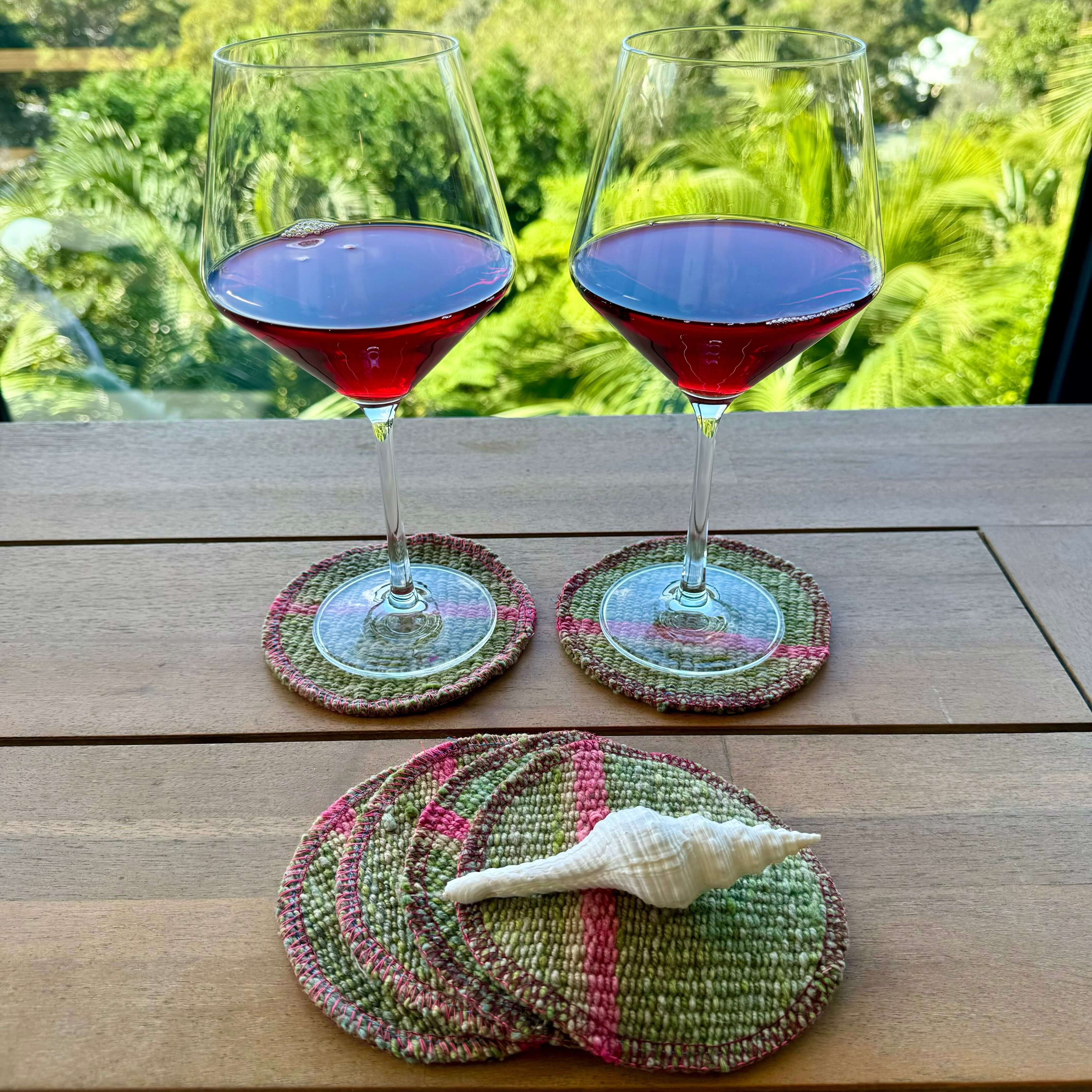 Handwoven circular wool coasters showing traditional Peruvian pattern and natural felt backing