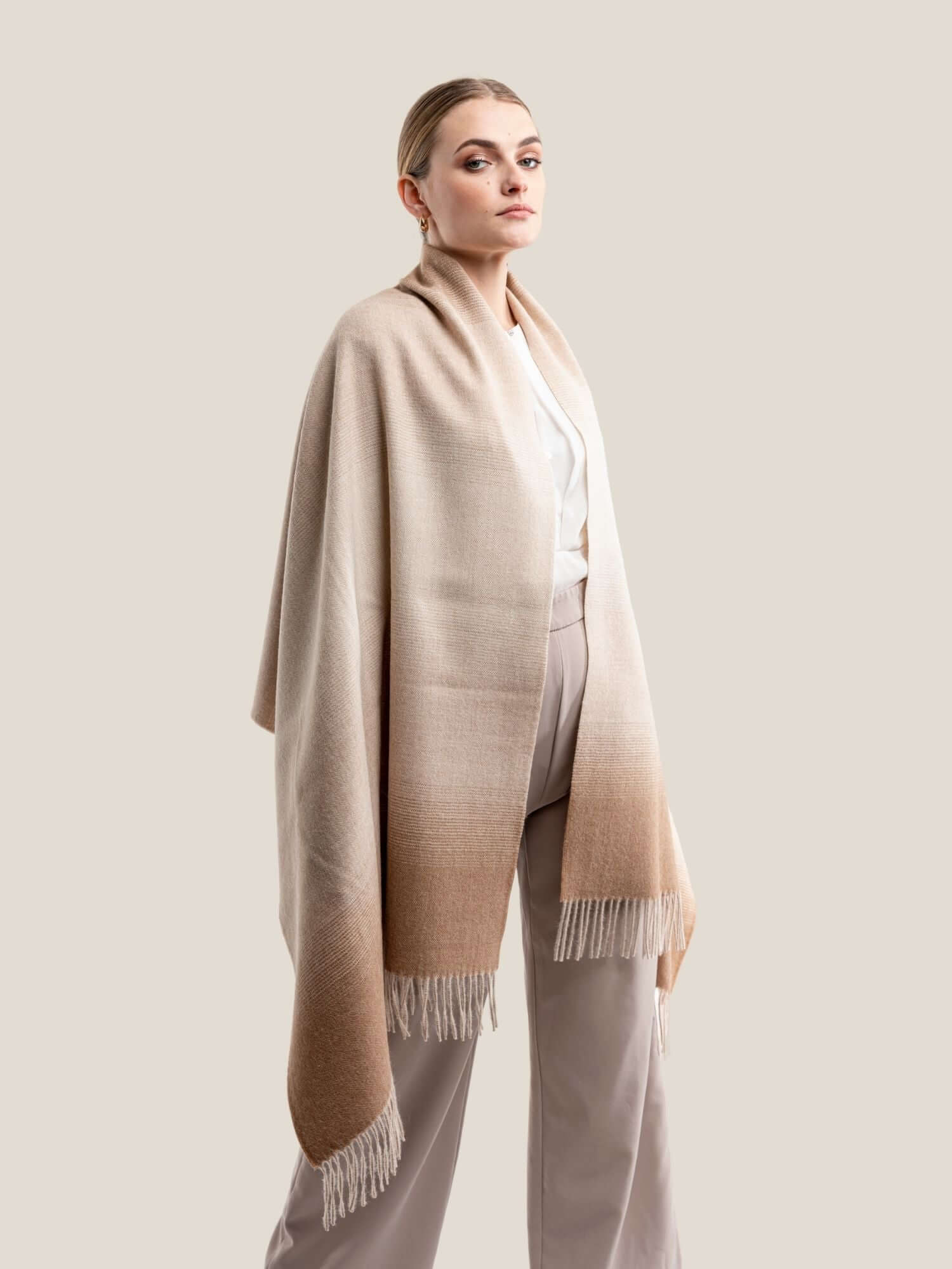 Close-up of soft alpaca degrade wool shawl showing luxurious fibre texture in beige and camel brown