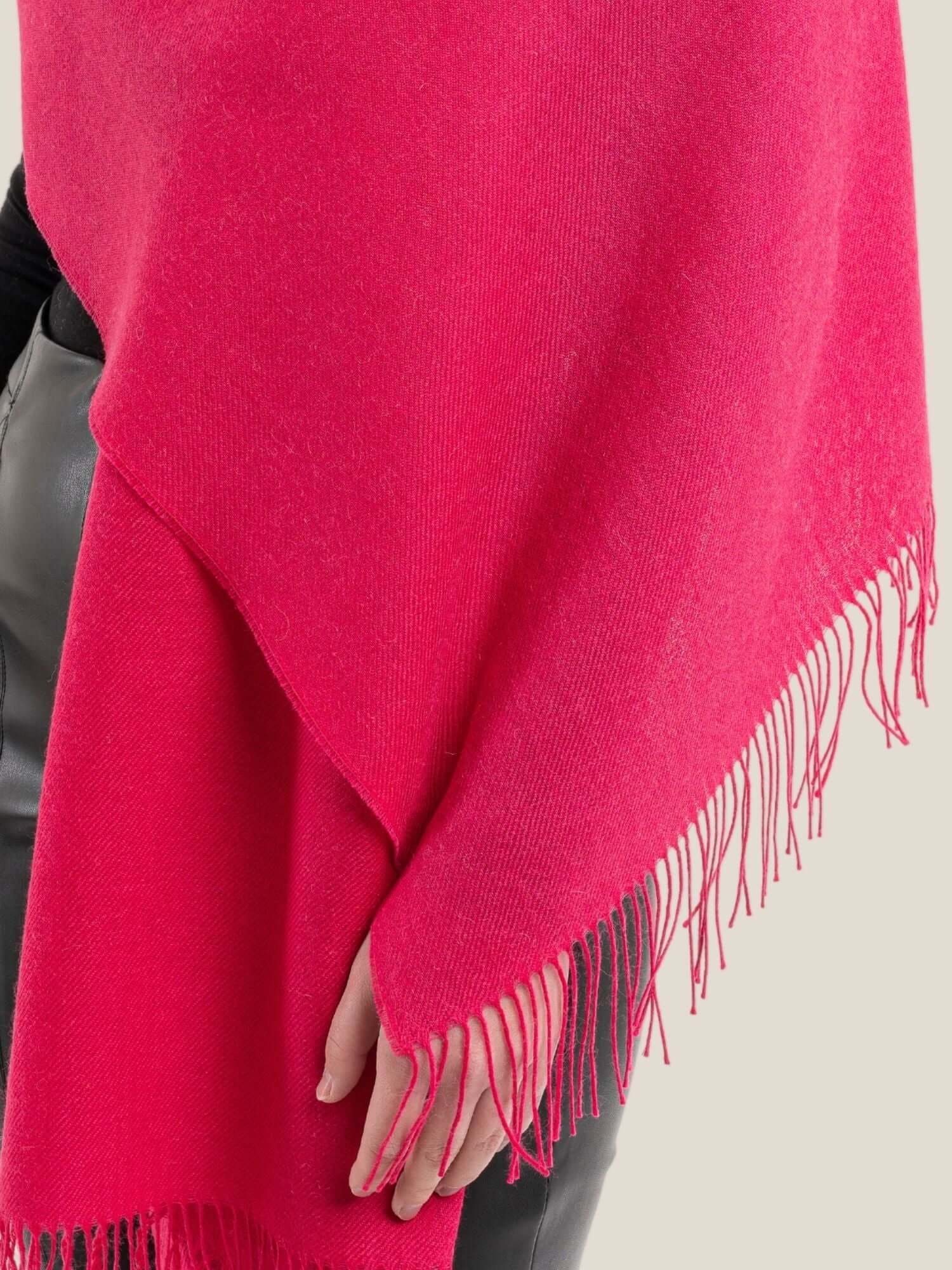 Close-up of soft alpaca wool shawl showing luxurious light fibre texture in fuchsia