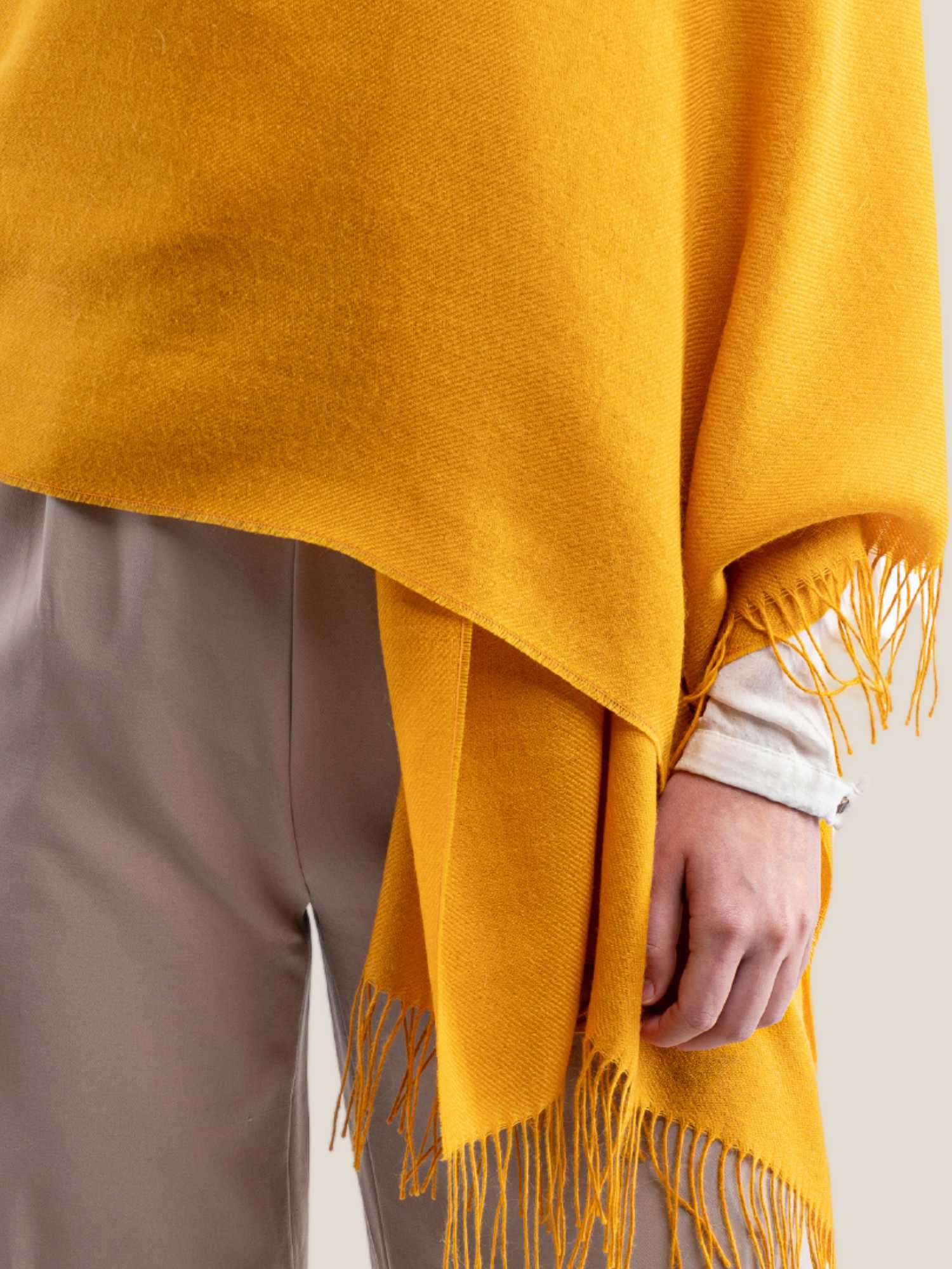 Yellow baby alpaca shawl worn – mid-body wrap detail with fringe edge | Orange Inca