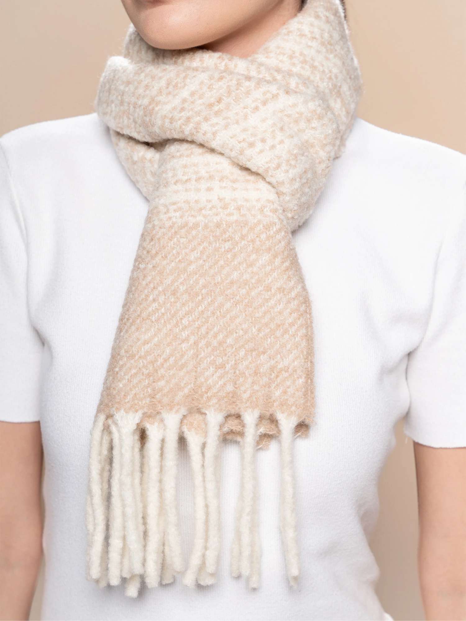 Close-up of beige and ivory striped bouclé scarf knot — chunky fringe and undyed alpaca-merino texture | Orange Inca