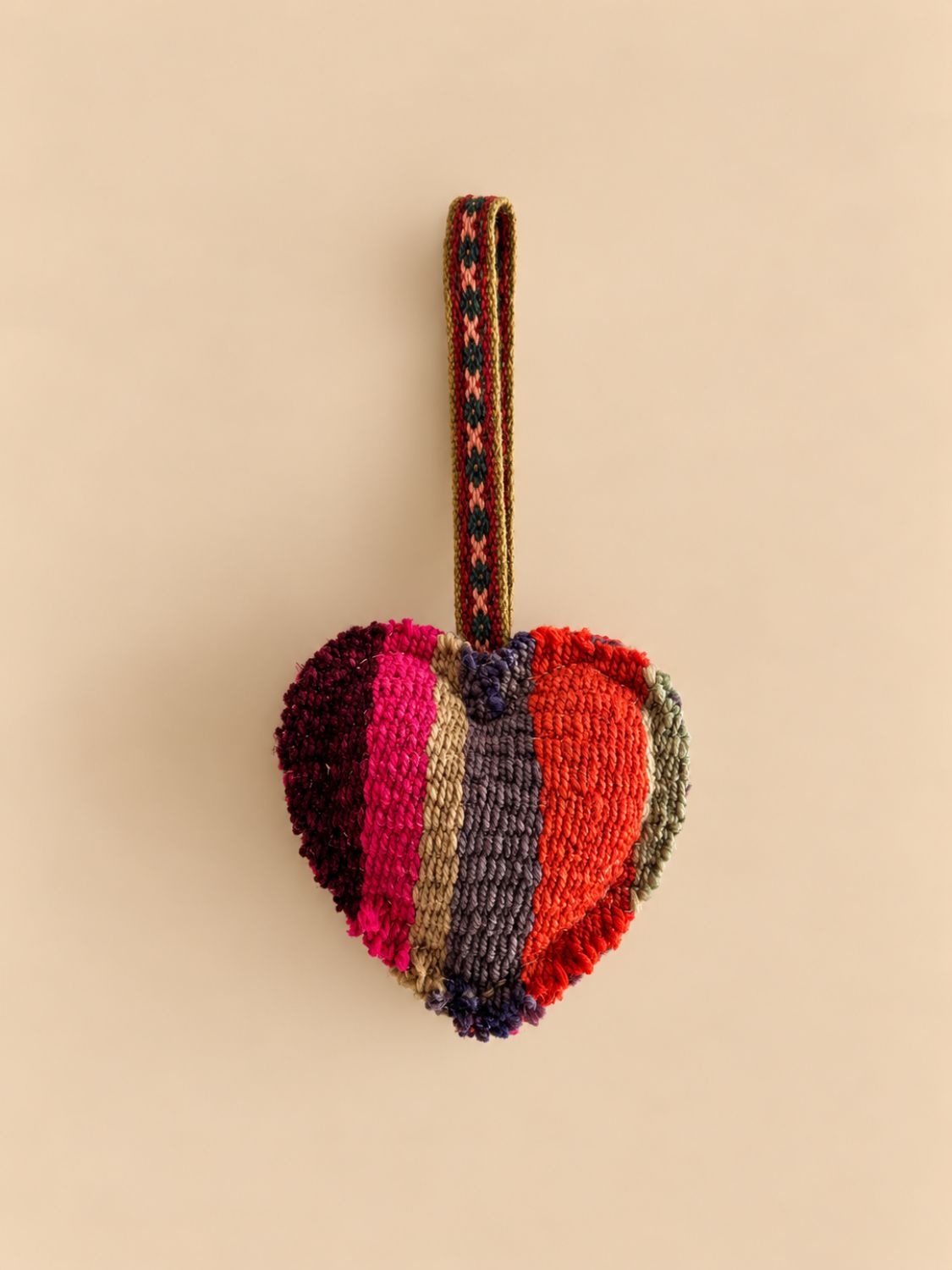 Medium heart wool charm in maroon, pink, tan and grey stripes, front view | Tasselita by Orange Inca