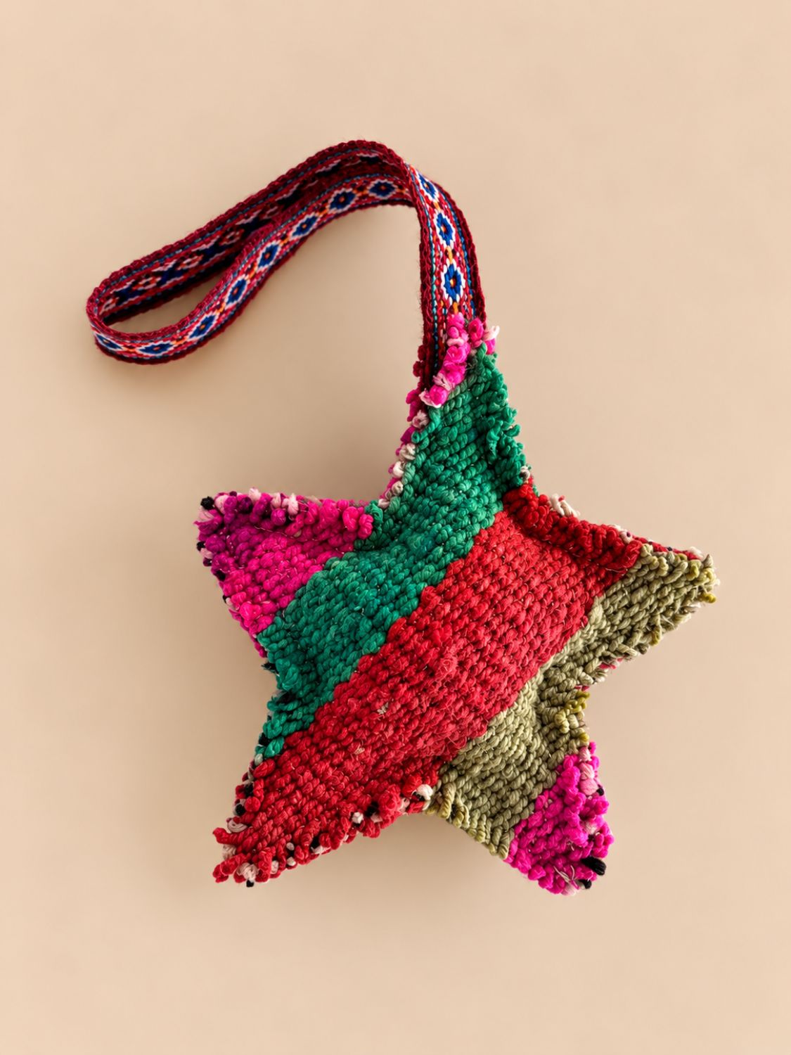 Large star wool charm in green, red, olive and pink panels with a woven loop | Tasselita by Orange Inca