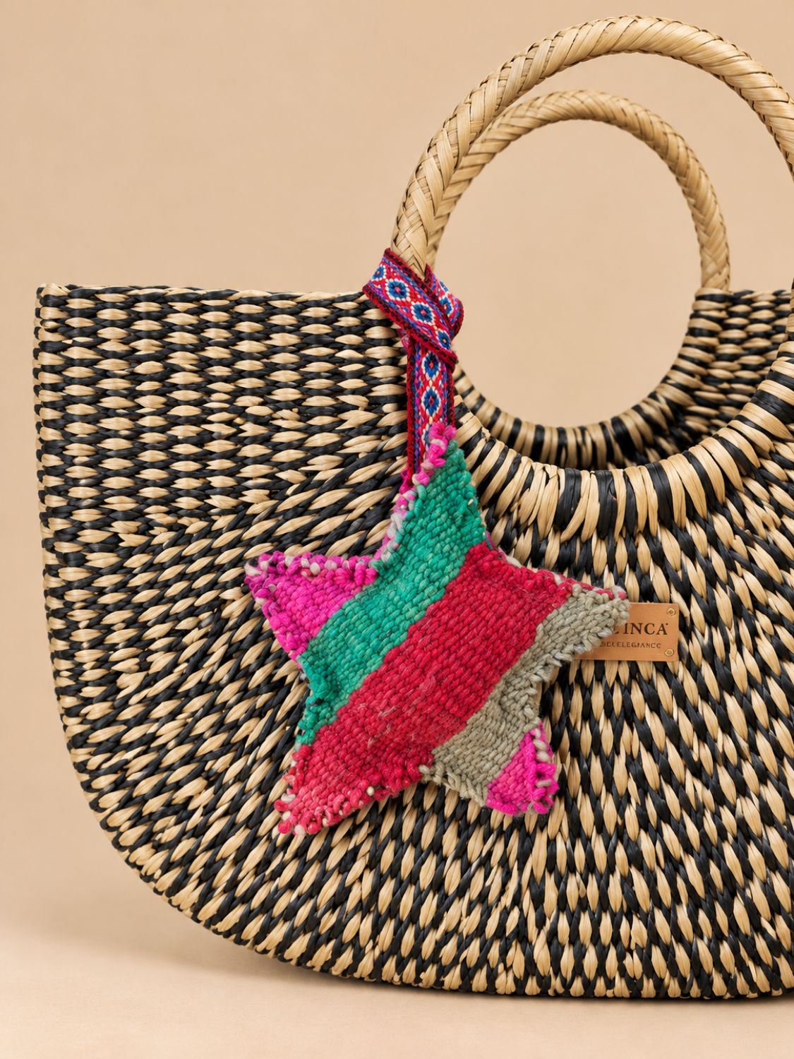 Large star wool charm on a black and natural straw bag | Tasselita by Orange Inca
