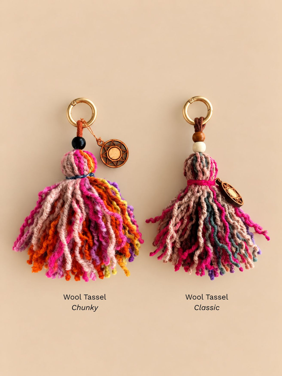 Chunky and classic wool tassel bag charms side by side, each with a light gold ring and a wooden sun charm, labelled Chunky and Classic | Tasselita by Orange Inca
