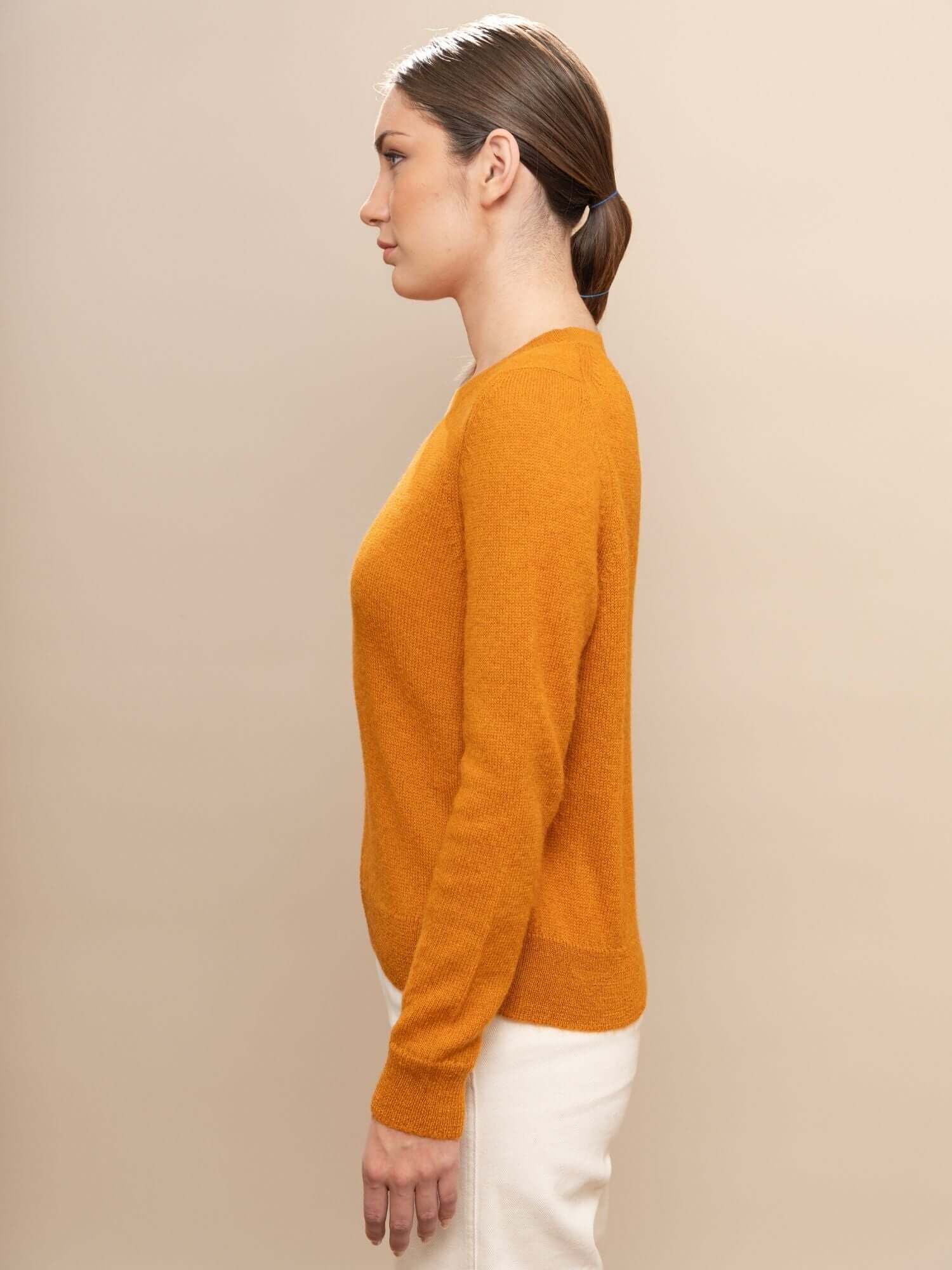 Side view of turmeric jumper showing natural fit and soft baby alpaca finish