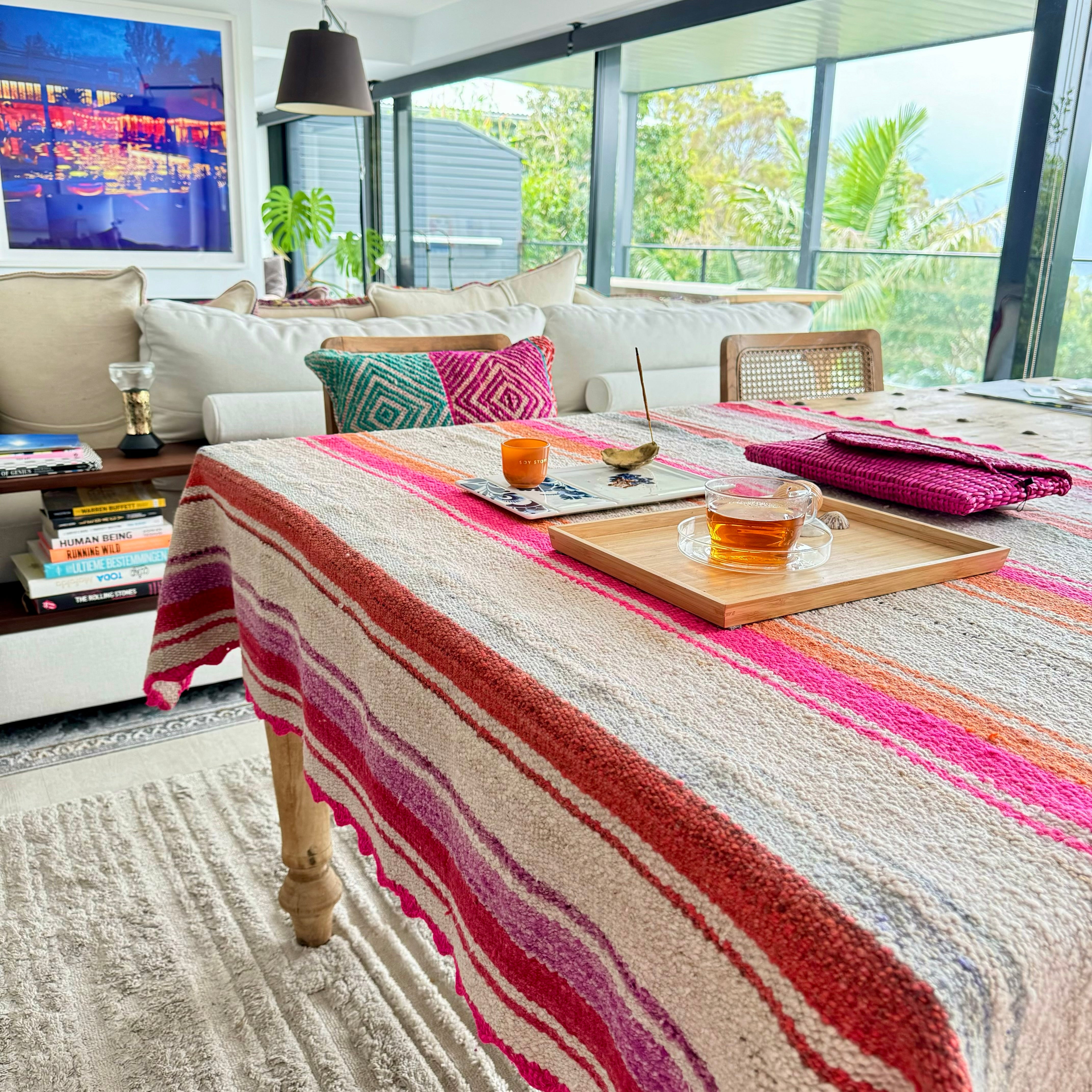 Beautiful classic Peruvian frazada in pinks and oranges used as a table cloth. So beautiful how those neutrals transform with it!