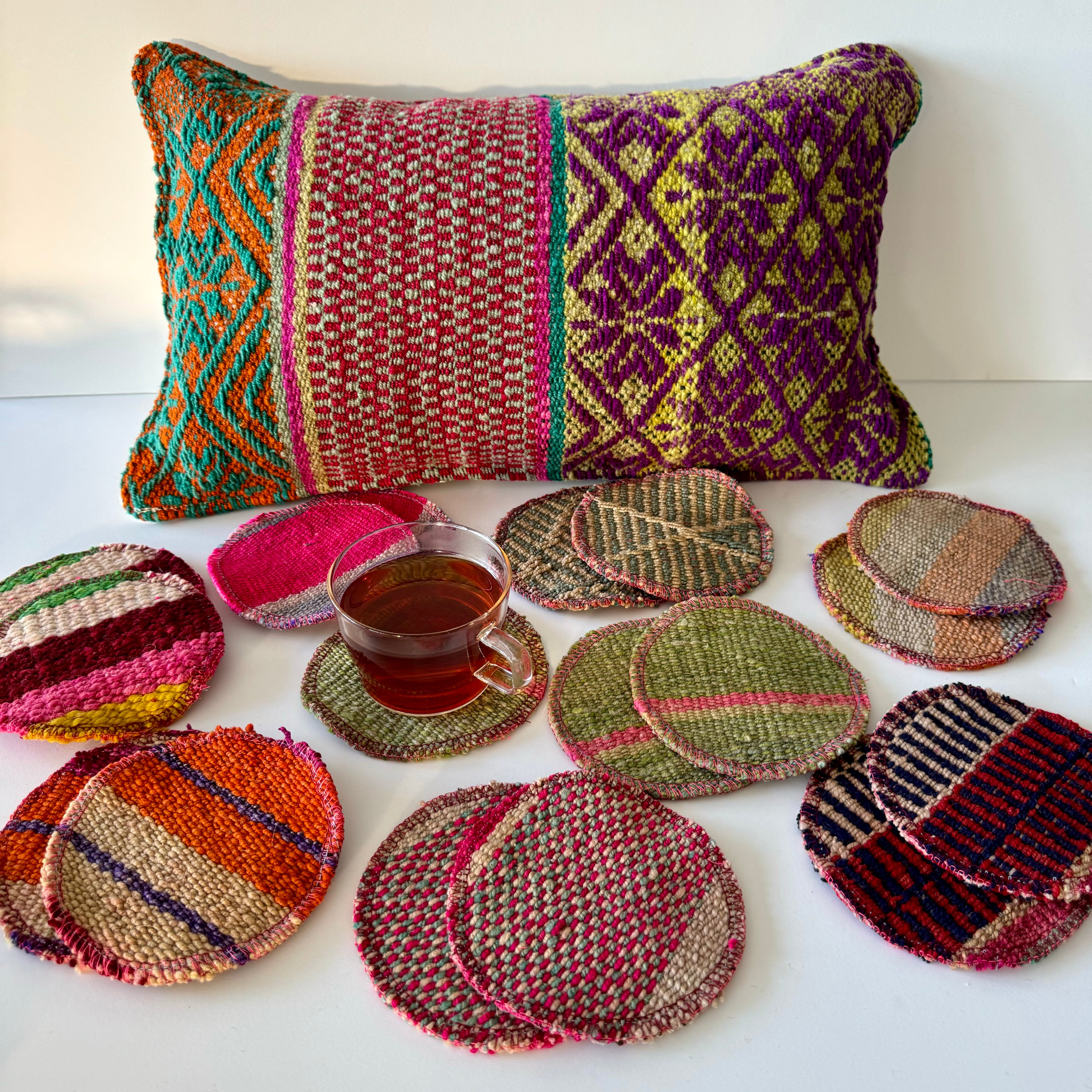 Set of bohemian wool drink coasters styled on table showing colourful textile patterns