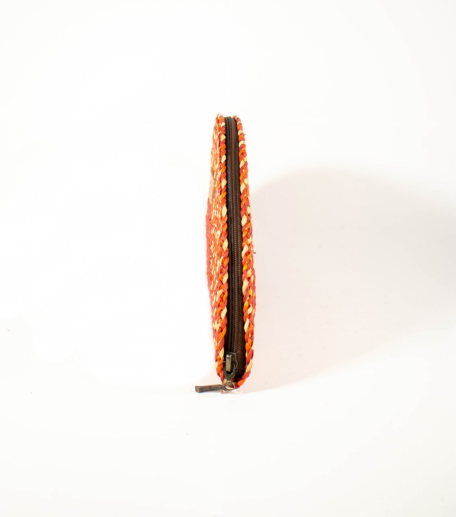 Side view of Flamenco Classic Clutch displaying the sleek profile and the quality of the junco weave.