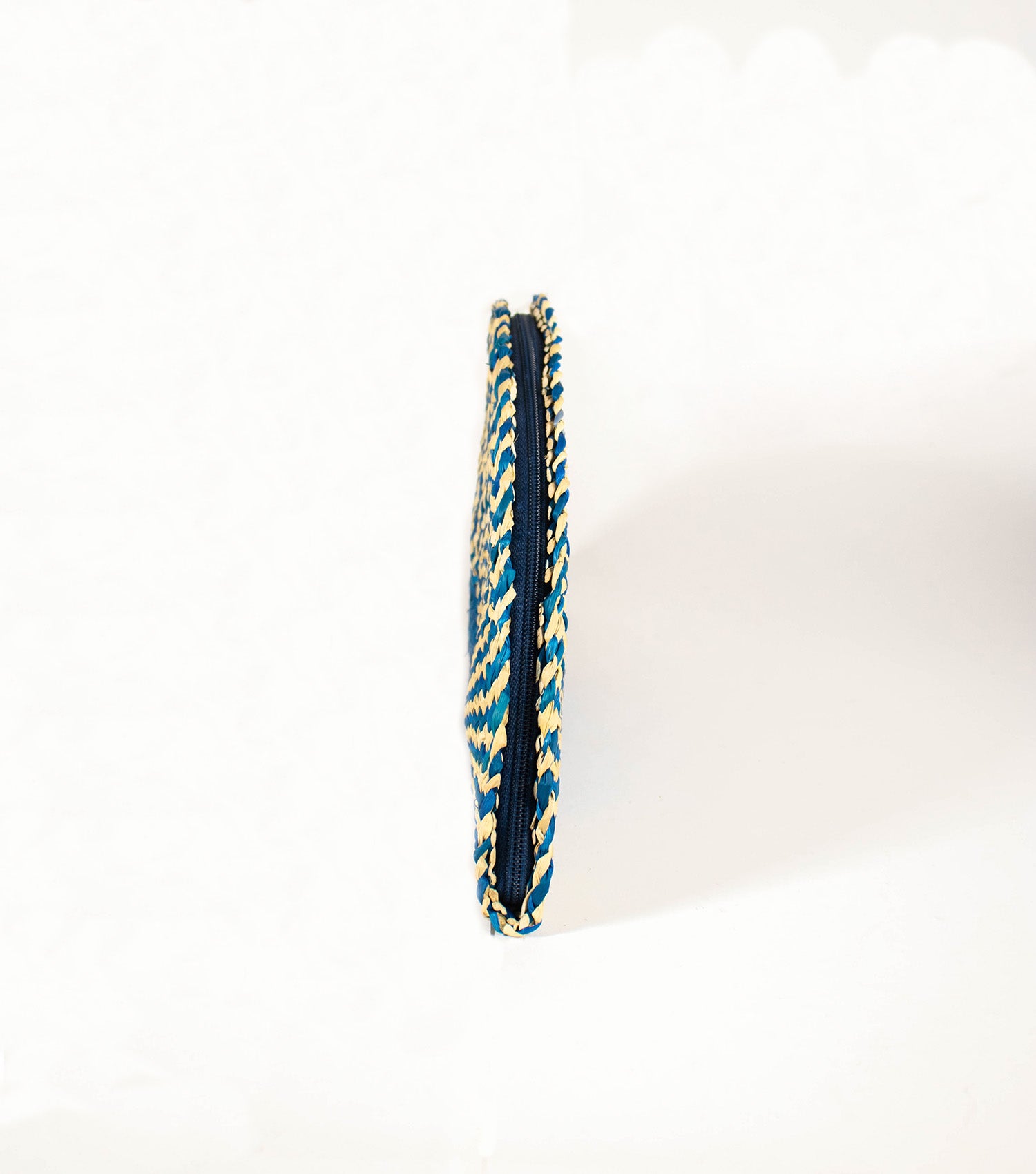 Side view of Flamenco Classic Clutch displaying the sleek profile and the quality of the junco weave.