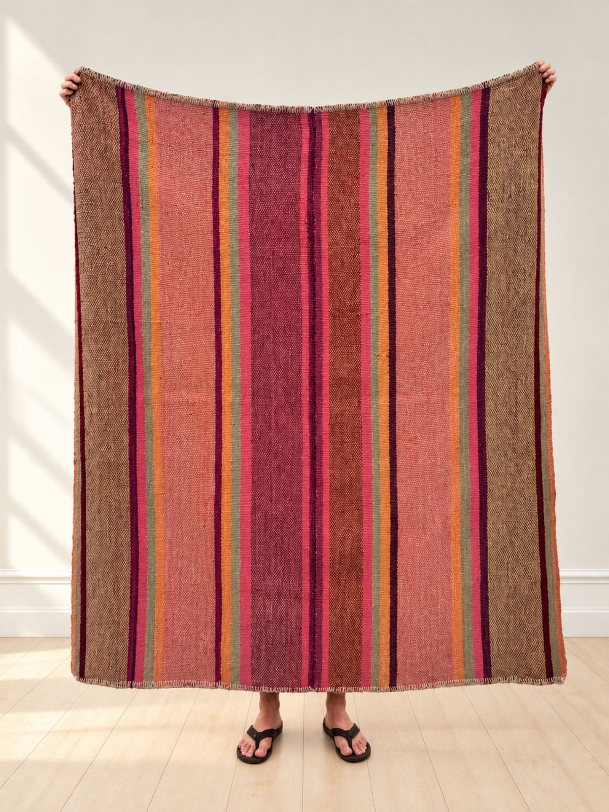 Vintage frazada rug No. 2 held up in full — rose, fuchsia, plum, peach and sage stripes, handwoven Peruvian sheep and alpaca wool, 160 × 155 cm | Orange Inca