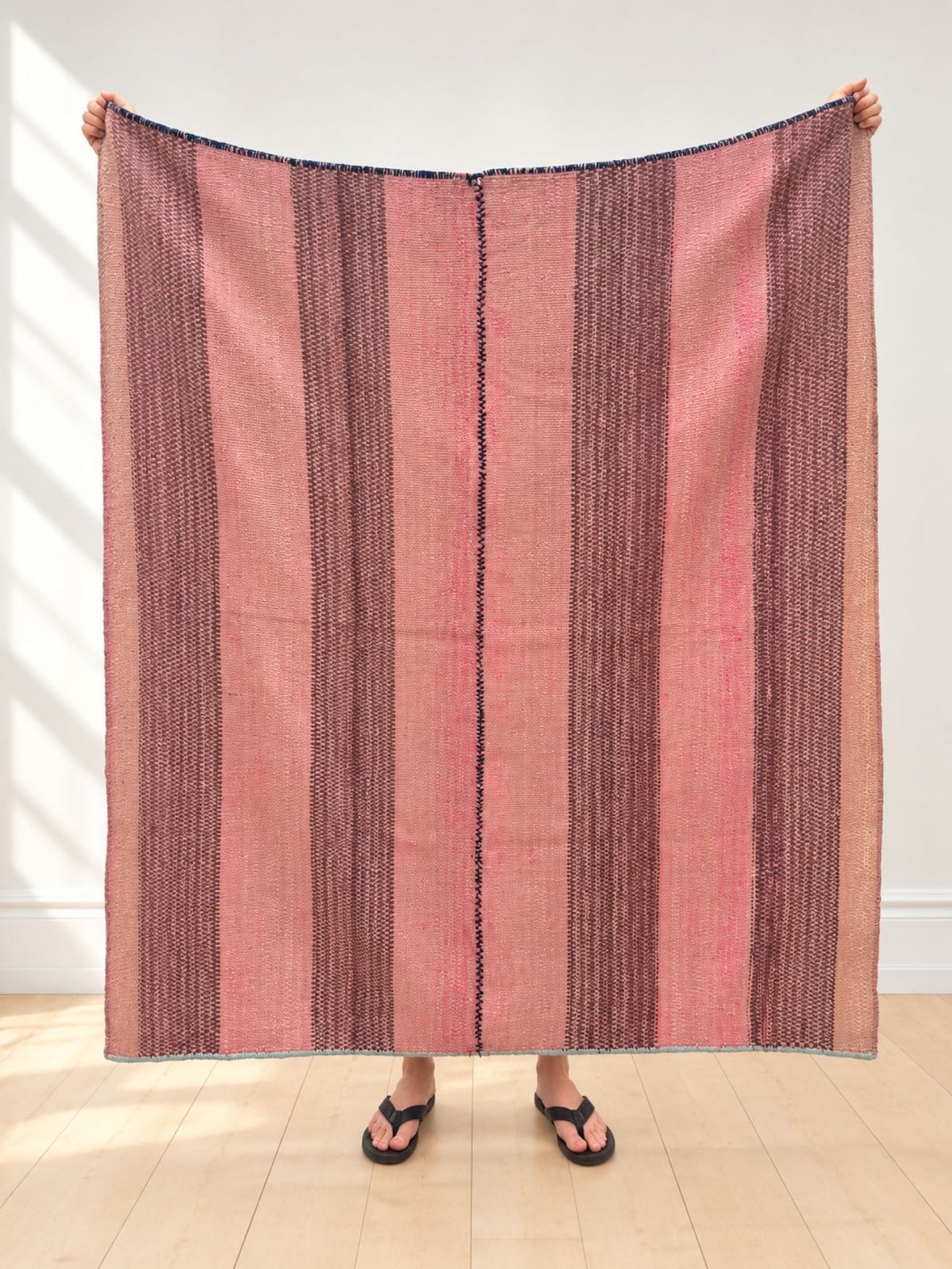 Vintage frazada rug No. 4 held up in full — dusty pink, plum and mauve, handwoven Peruvian sheep and alpaca wool, 170 × 160 cm | Orange Inca