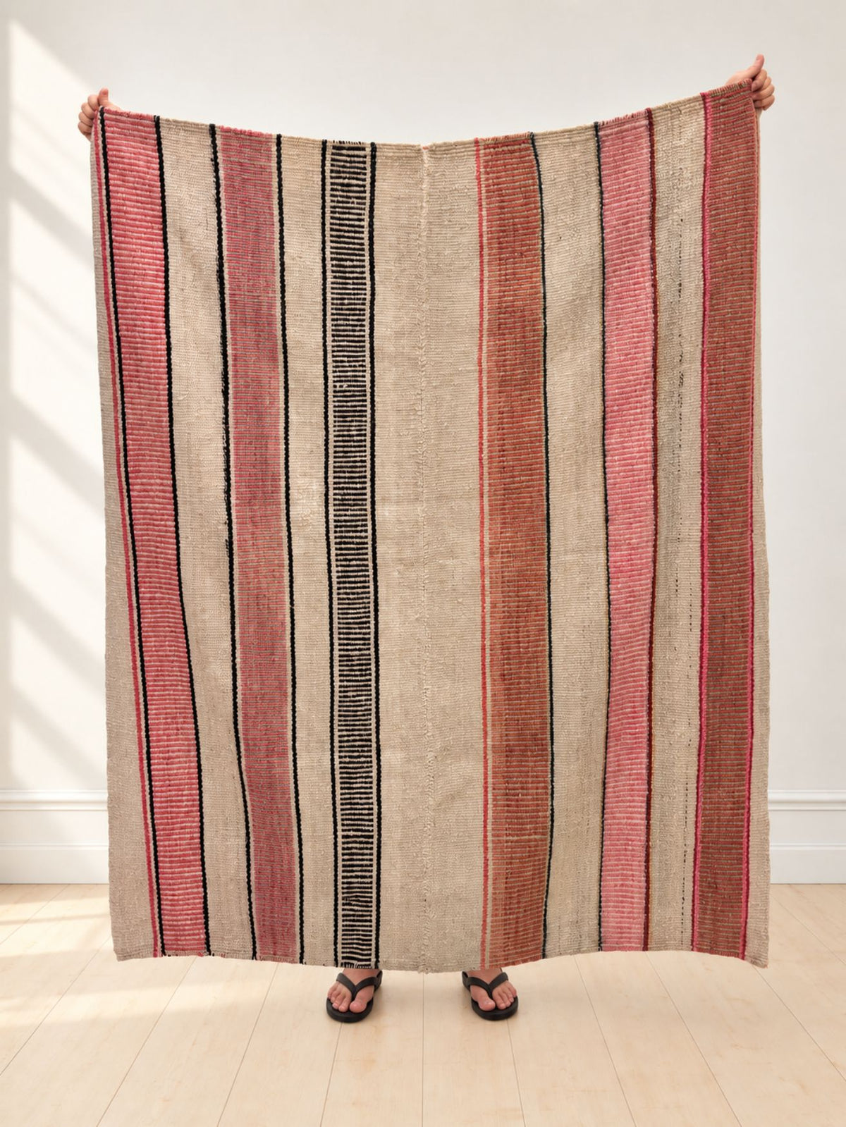 Vintage frazada rug No. 7 held up in full — ivory, coral pink and black, handwoven Peruvian sheep and alpaca wool, 174 × 160 cm | Orange Inca