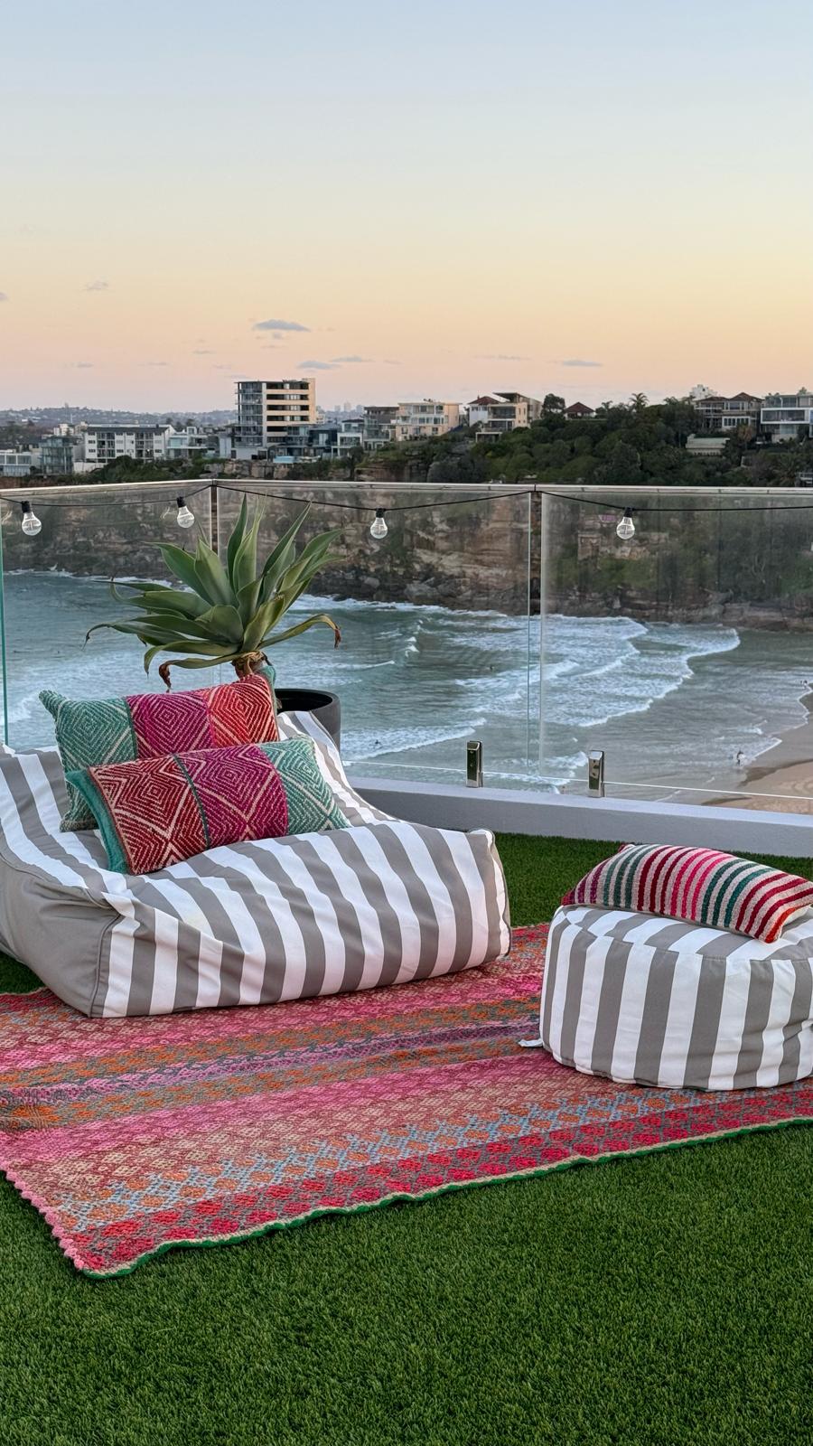 Stunning Deck Setting overseeing Freshwater. Decorated with a Peruvian Frazada Rug and Throw and lumbar Peruvian Frazada Cushions, at sunset time.