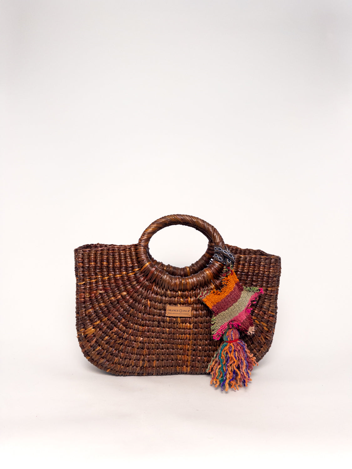 Gran Fiesta Crossbody Tote - Brown, handwoven junco tote bag, structured handbag with top handles and colorful tassel.