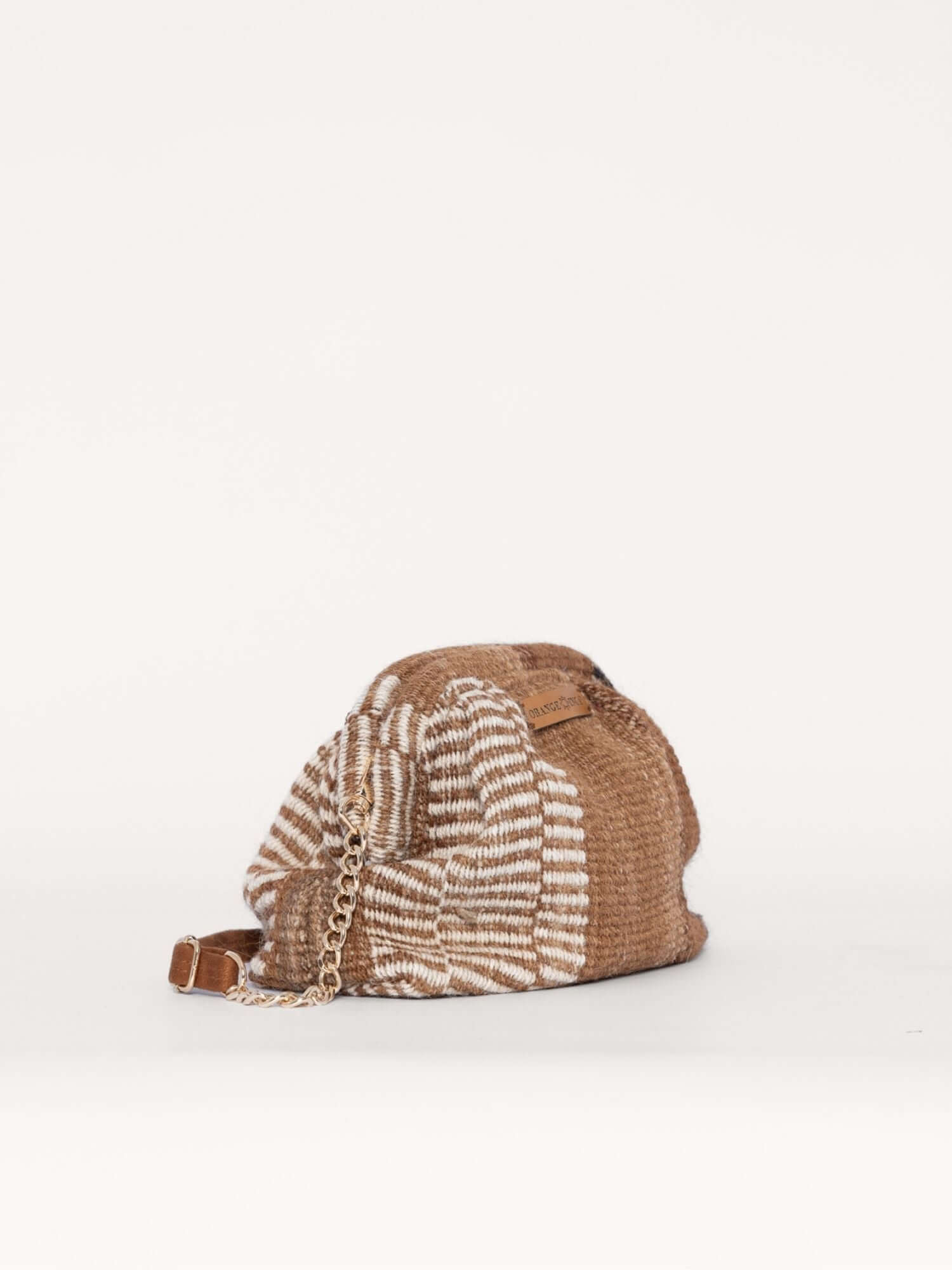 Diagonal view of vintage-inspired kiss lock clutch – artisan-made alpaca wool bag with soft structure