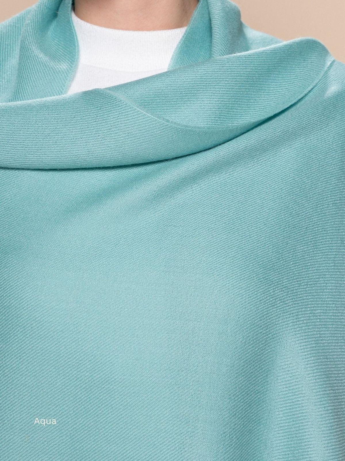 Aqua naturally dyed baby alpaca shawl wrapped around the neck and shoulders, soft pale blue-green wrap