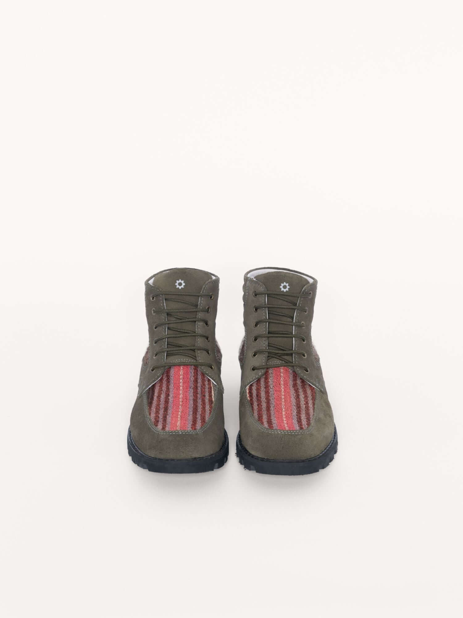 Durable handcrafted leather boots with wool accents, front view.