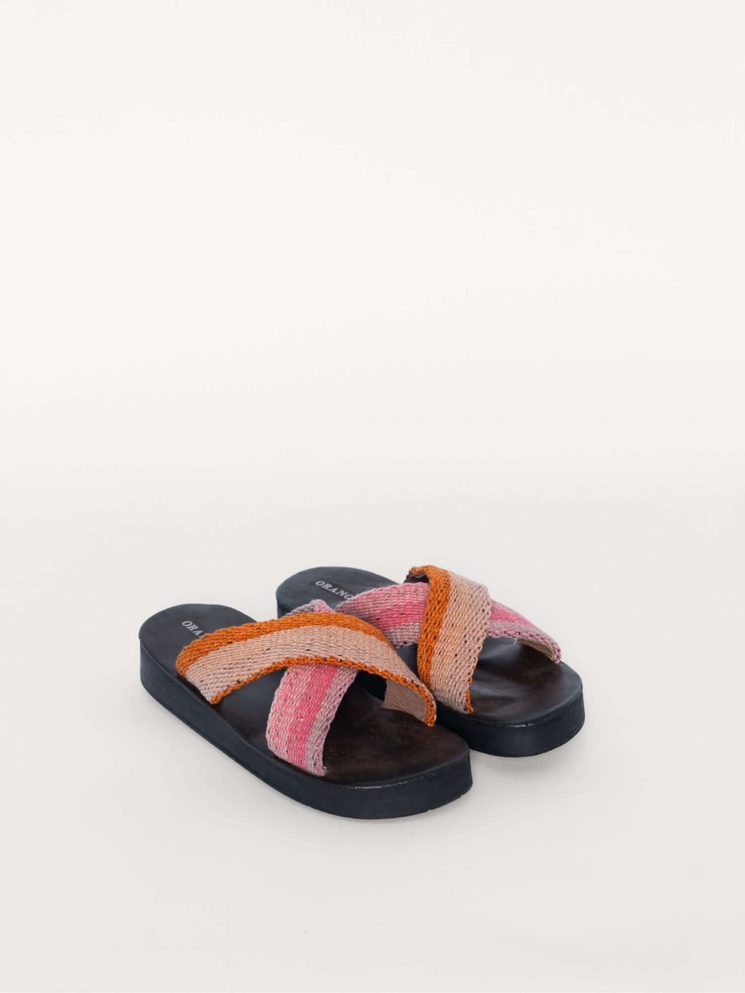Pink and orange handcrafted wool and leather x  sandals, front view.