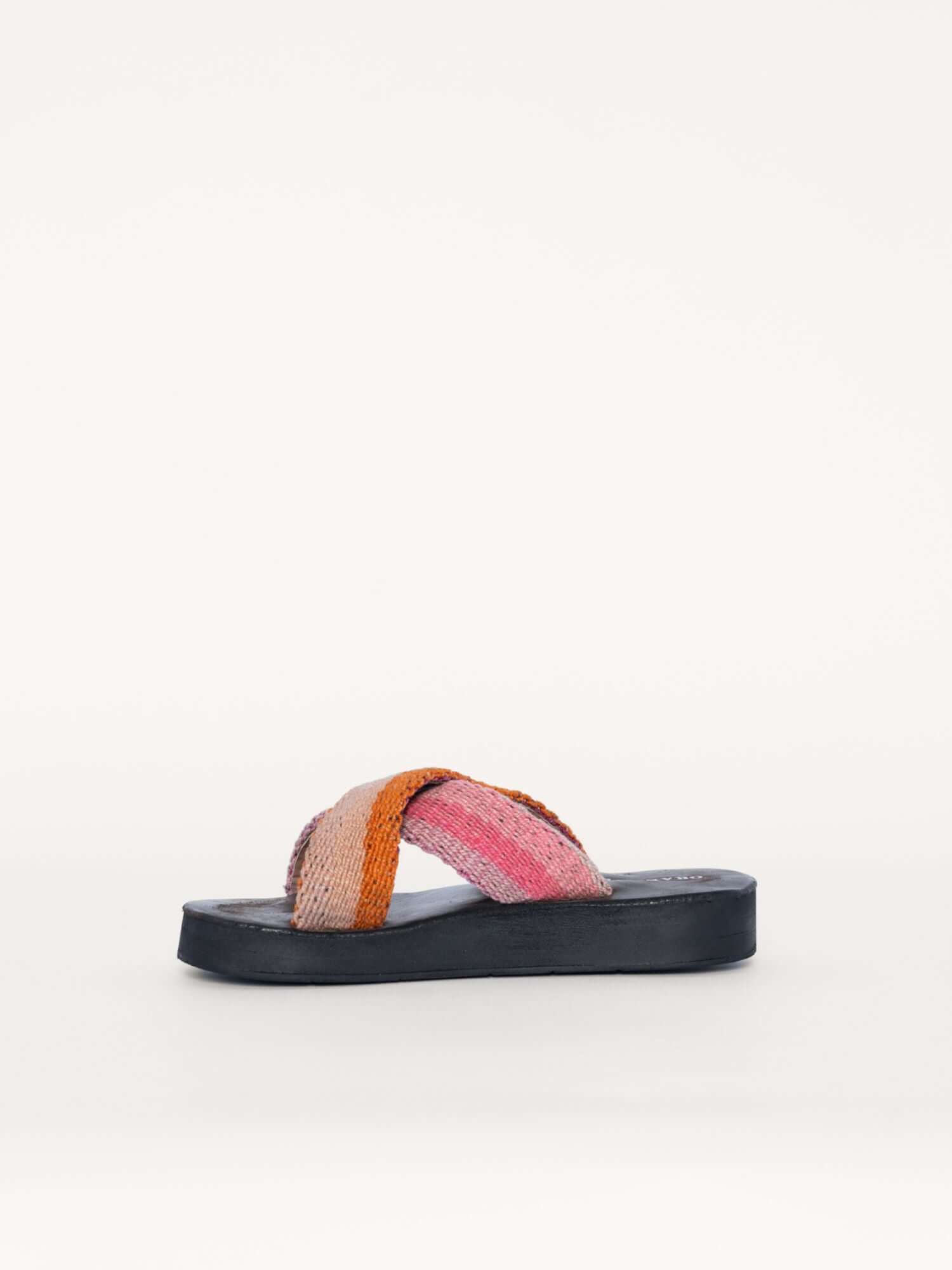 Handwoven wool and leather x sandals in pink and orange, left side view.