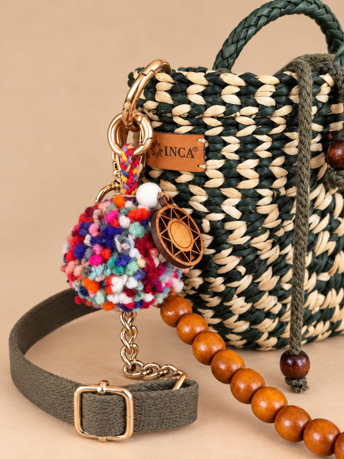 Wool pom-pom bag charm attached to a bag chain | Tasselita by Orange Inca