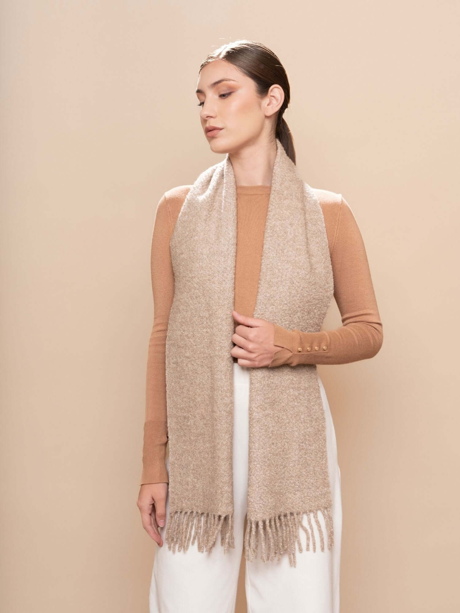 Full-length view of model in neutral outfit wearing undyed oatmeal bouclé scarf, lightweight and breathable