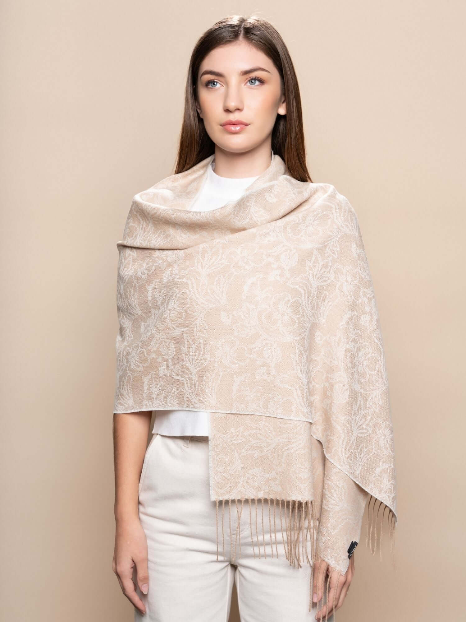 Model draped in floral beige baby alpaca scarf, naturally hypoallergenic and breathable