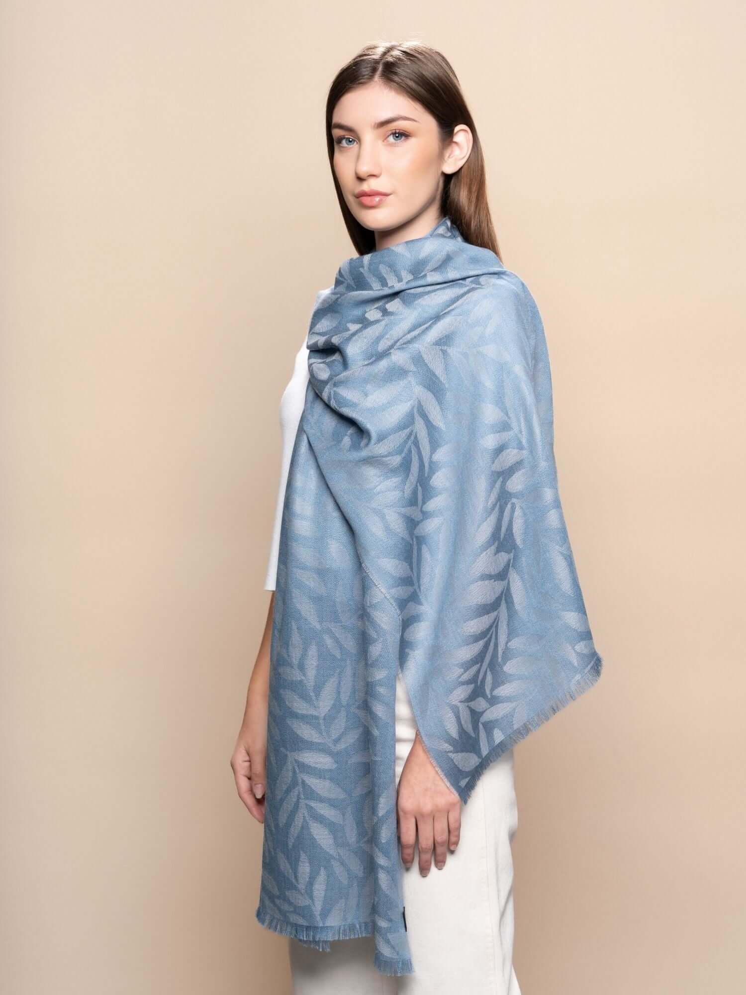 Model wearing steel blue baby alpaca jacquard scarf, breathable and lightweight layering wrap