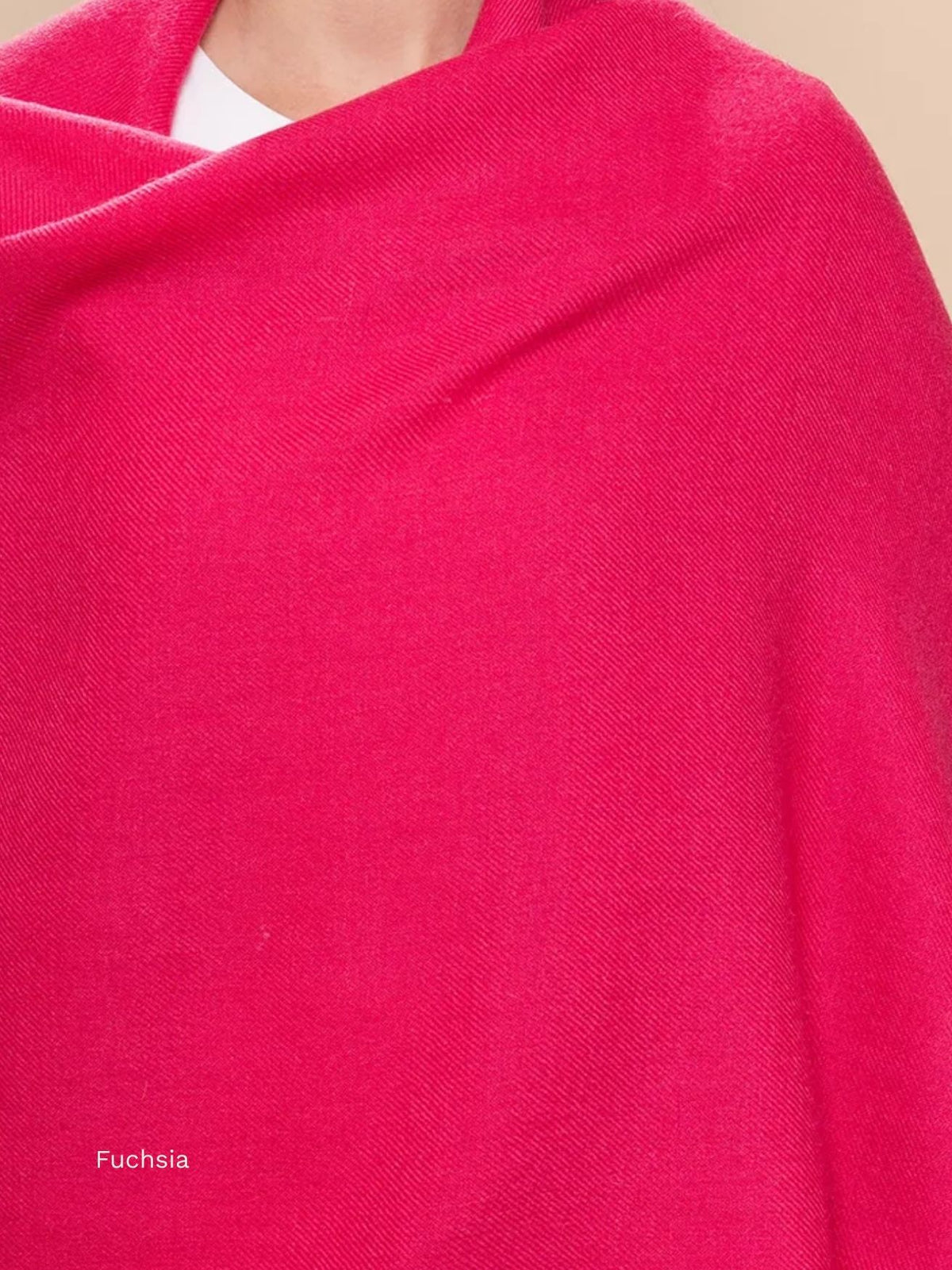Fuchsia silk baby alpaca blend shawl draped around the shoulders, bright pink solid colour