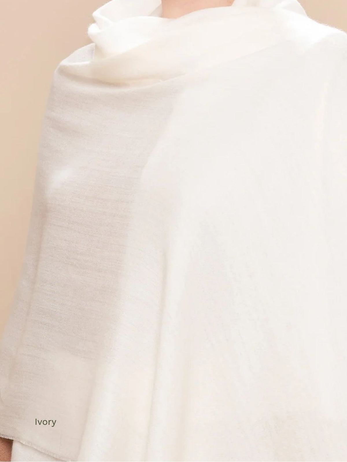 Ivory silk baby alpaca blend shawl draped over the shoulders, soft cream solid colour