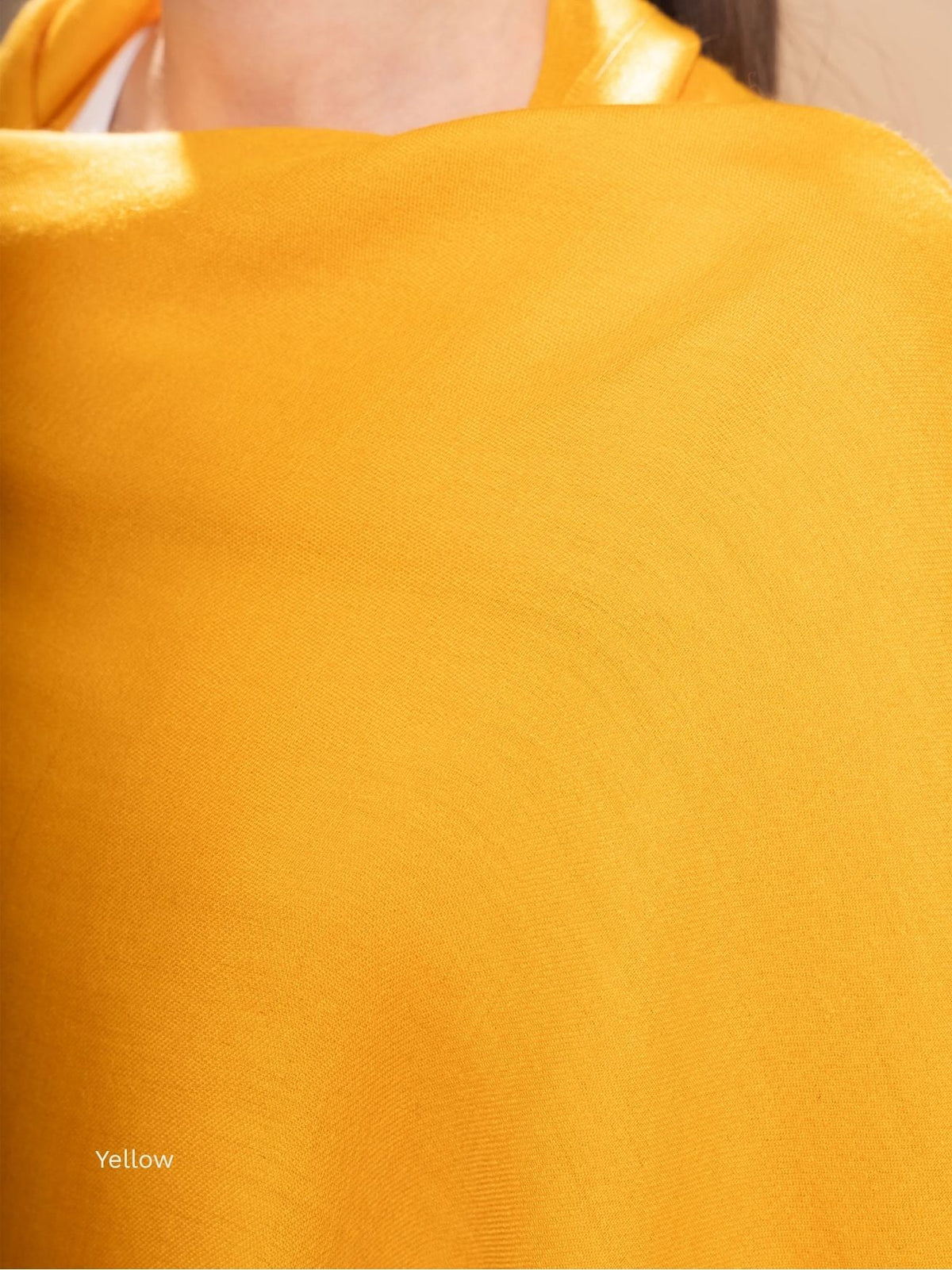 Yellow silk baby alpaca blend shawl, close-up of the fine lustrous fabric at the neckline