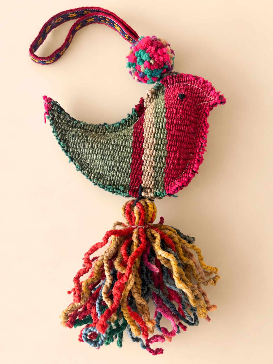 Large bird wool tassel in crimson, olive green and pink with a multicolour pom pom, wool tassel and woven strap – handmade in Peru | Tasselita by Orange Inca