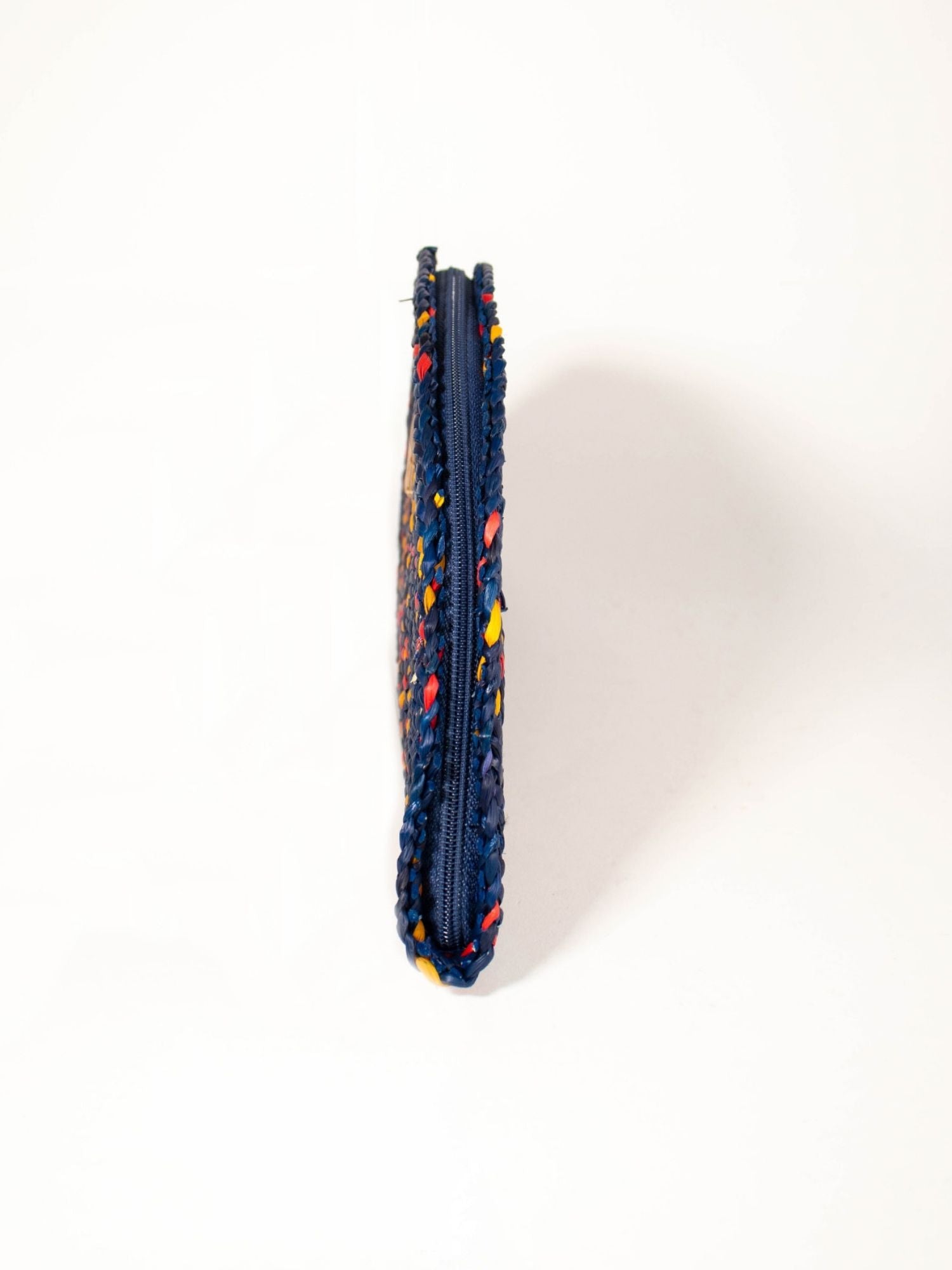 Detail of handwoven natural reed weave, Flamenco Clutch – Navy Blue | Orange Inca